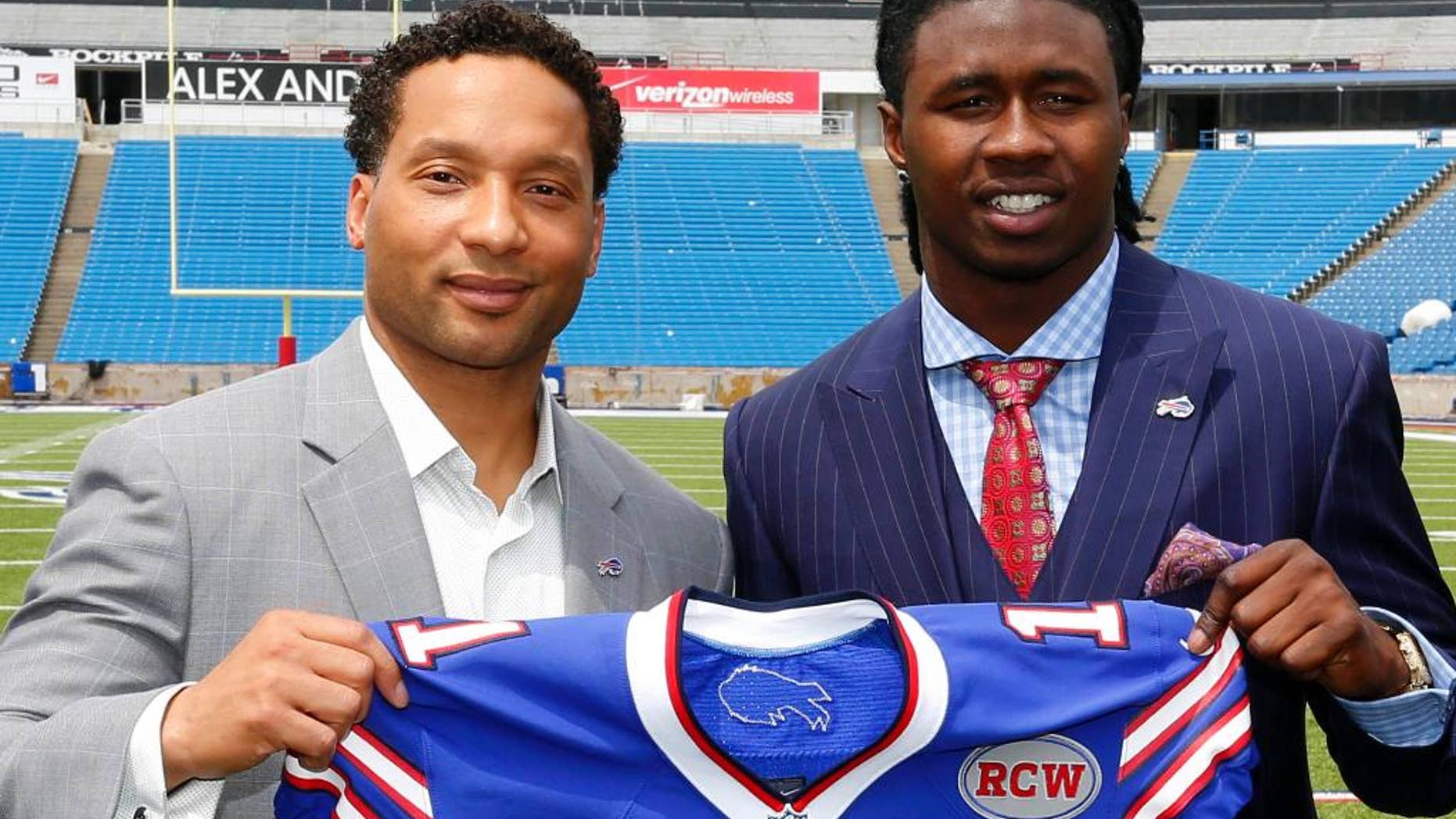 FILE- In this May 9, 2014, file photo, Buffalo Bills first-round draft pick Sammy Watkins, right, poses for photos with general manager Doug Whaley at Ralph Wilson Stadium in Orchard Park, N.Y. Whaley's swing-for-the-fences philosophy is evident in the new-look offense the Bills will unveil Sunday, when they open training camp in suburban Rochester. There's rookie receiver Sammy Watkins, who was drafted fourth overall after Whaley traded Buffalo's 2015 first-round pick to Cleveland. (AP Photo/Bill Wippert, File)