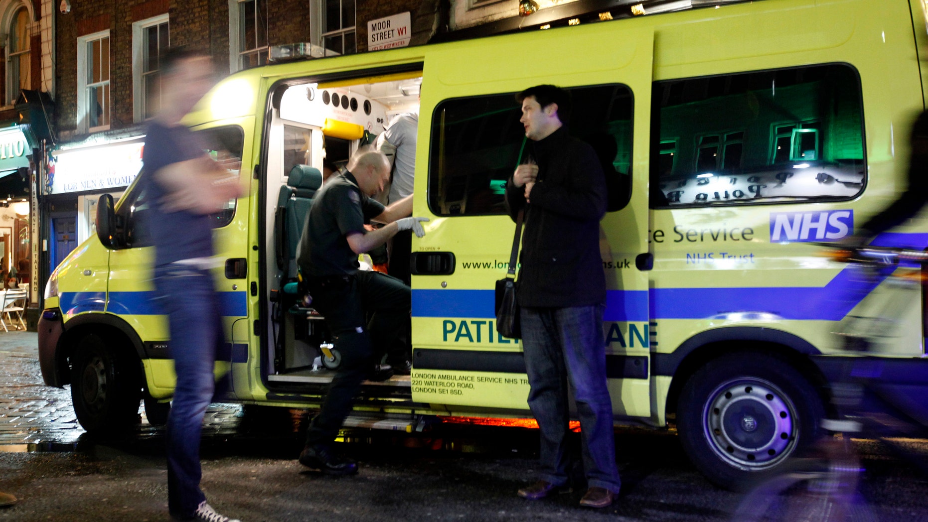 April 21: A man is taken into the ambulance, known as a 'booze bus,' dedicated to keeping drunk people out of trouble on the streets, and out of hospital emergency rooms in the Soho area of central London.