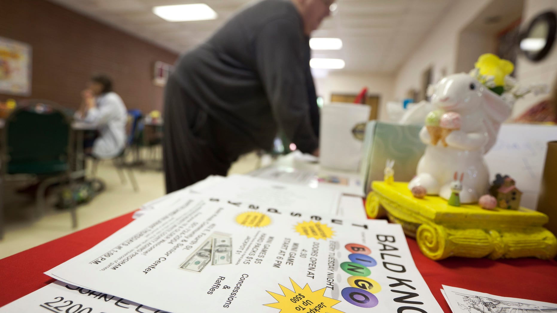 April 10: John Lancaster from Floyd, Ark., buys Bingo cards before a game in Bald Knob, Ark.