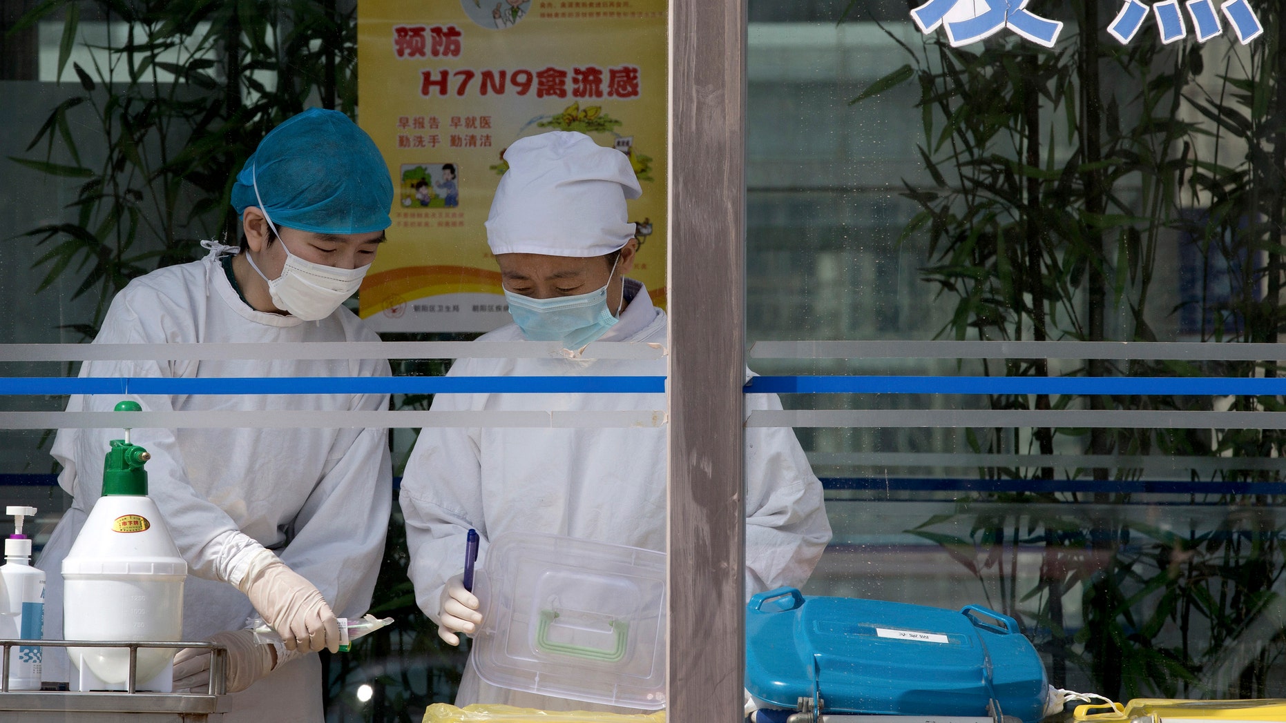 Nurses collect patients' blood samples at a specialized fever clinic inside the Ditan Hospital in Beijing.