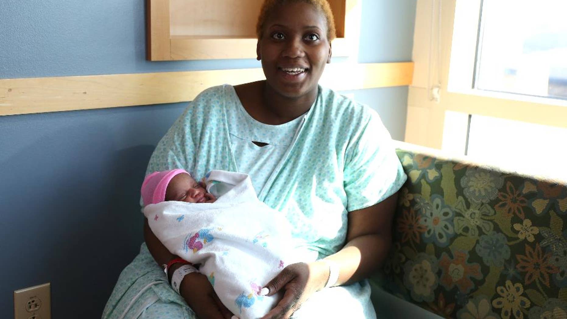 Brittany Young, 24, of Des Moines, Iowa, went into labor and had delivered her baby, Miracle, in the shower of her apartment. Young knew she was pregnant, but thought she was earlier along than she was on Wednesday, March 11, 2015, Des Moines, Iowa. (AP Photo/The Des Moines Register, Bryon Houlgrave)