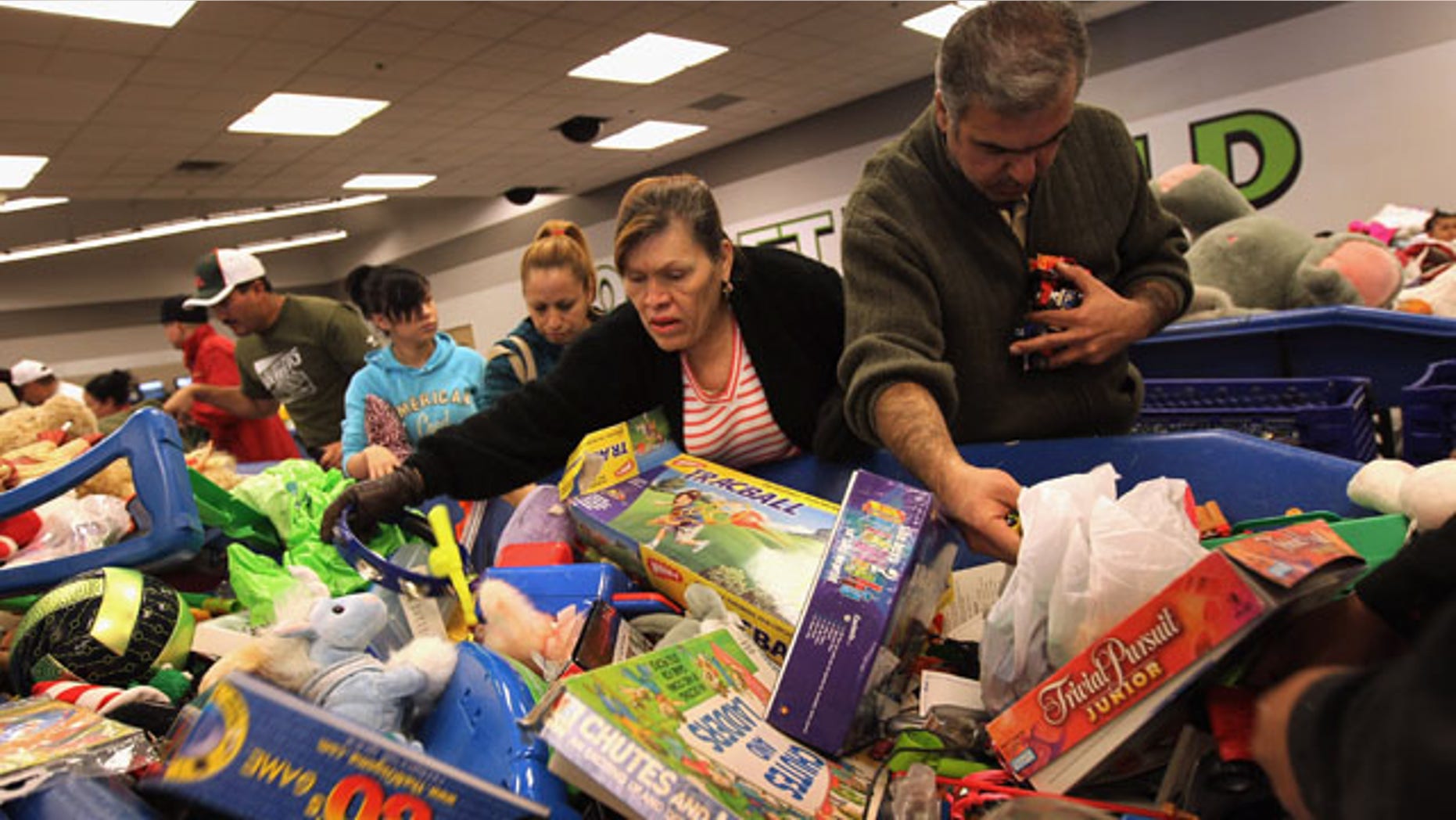 DENVER - NOVEMBER 26: Low-income shoppers search bins for toys at a Goodwill thrift store on Black Friday, November 26, 2010 in Denver, Colorado. People packed the thrift store on the busiest shopping day of the year, buying toys and clothes in bulk for as cheap as 59 cents a pound. (Photo by John Moore/Getty Images)