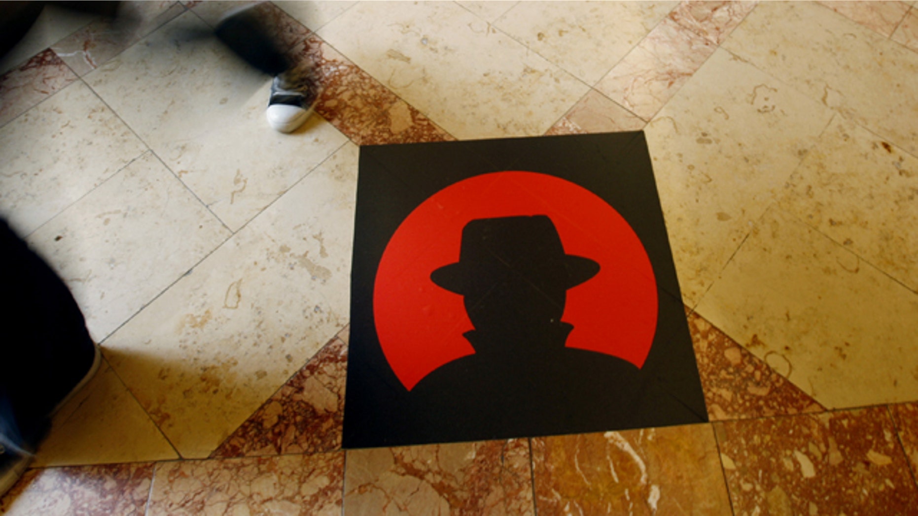 A man passes a logo of the Black Hat technology conference in Las Vegas on Wednesday, July 28, 2010.