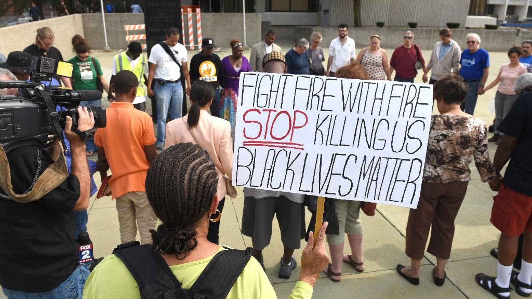 In this Friday, Aug. 28, 2015 photo, dozens of people gather during a rally outside the Frank Murphy Hall of Justice in Detroit regarding the shooting death of Terrance Kellom by an U.S. Immigration and Customs Enforcement (ICE) officer in April 2015. As the Black Lives Matter movement gains more public attention, there are questions being raised about who’s in charge of the movement and what its long-term goals are. (Max Ortiz/The Detroit News via AP)