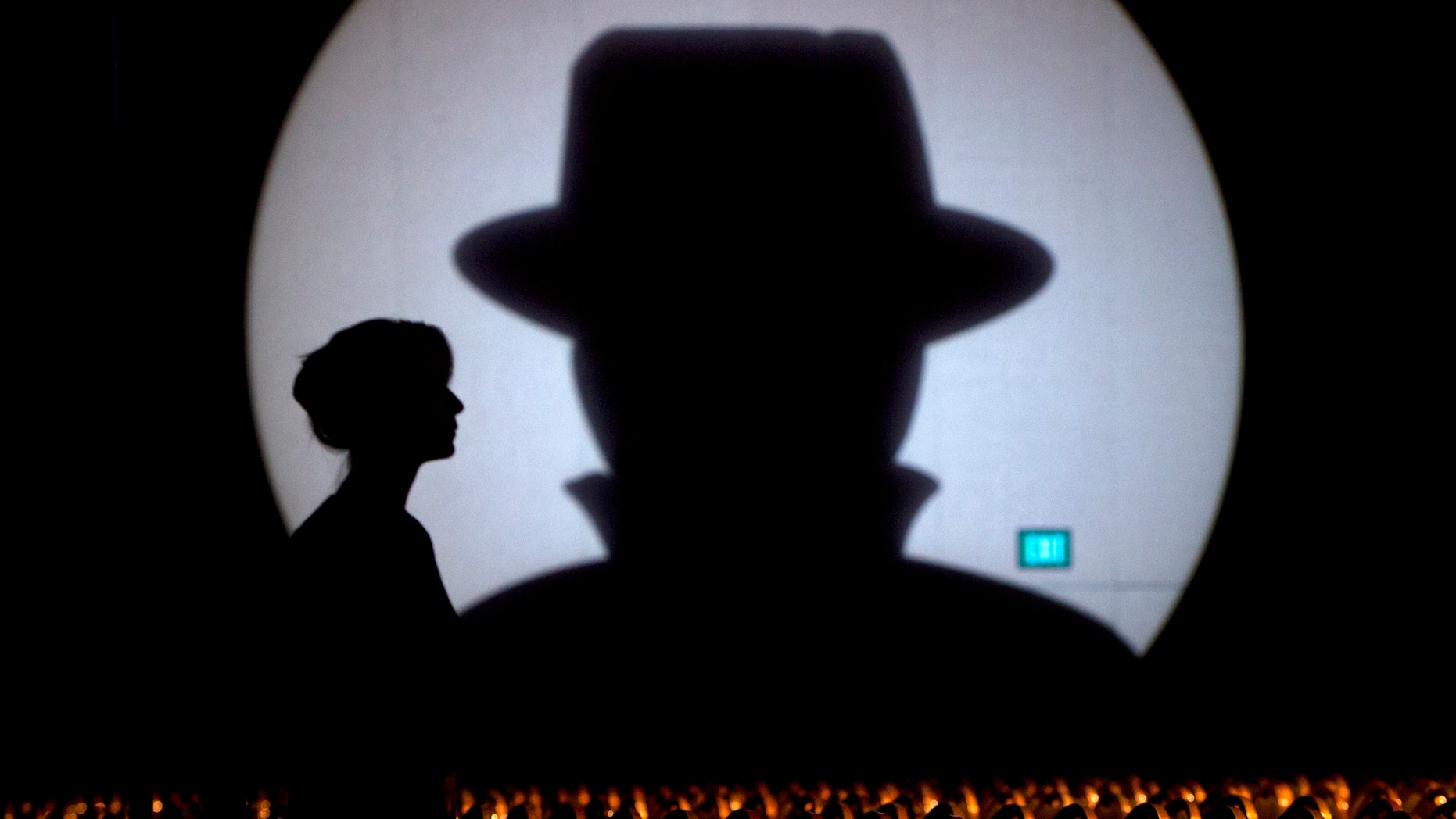 Speaker liaison Genevieve Netter is silhouetted against a Black Hat logo during the Black Hat USA 2014 hacker conference at the Mandalay Bay Convention Center in Las Vegas, Nevada August 6, 2014. REUTERS/Steve Marcus (UNITED STATES - Tags: SCIENCE TECHNOLOGY TPX IMAGES OF THE DAY) - RTR41H1N