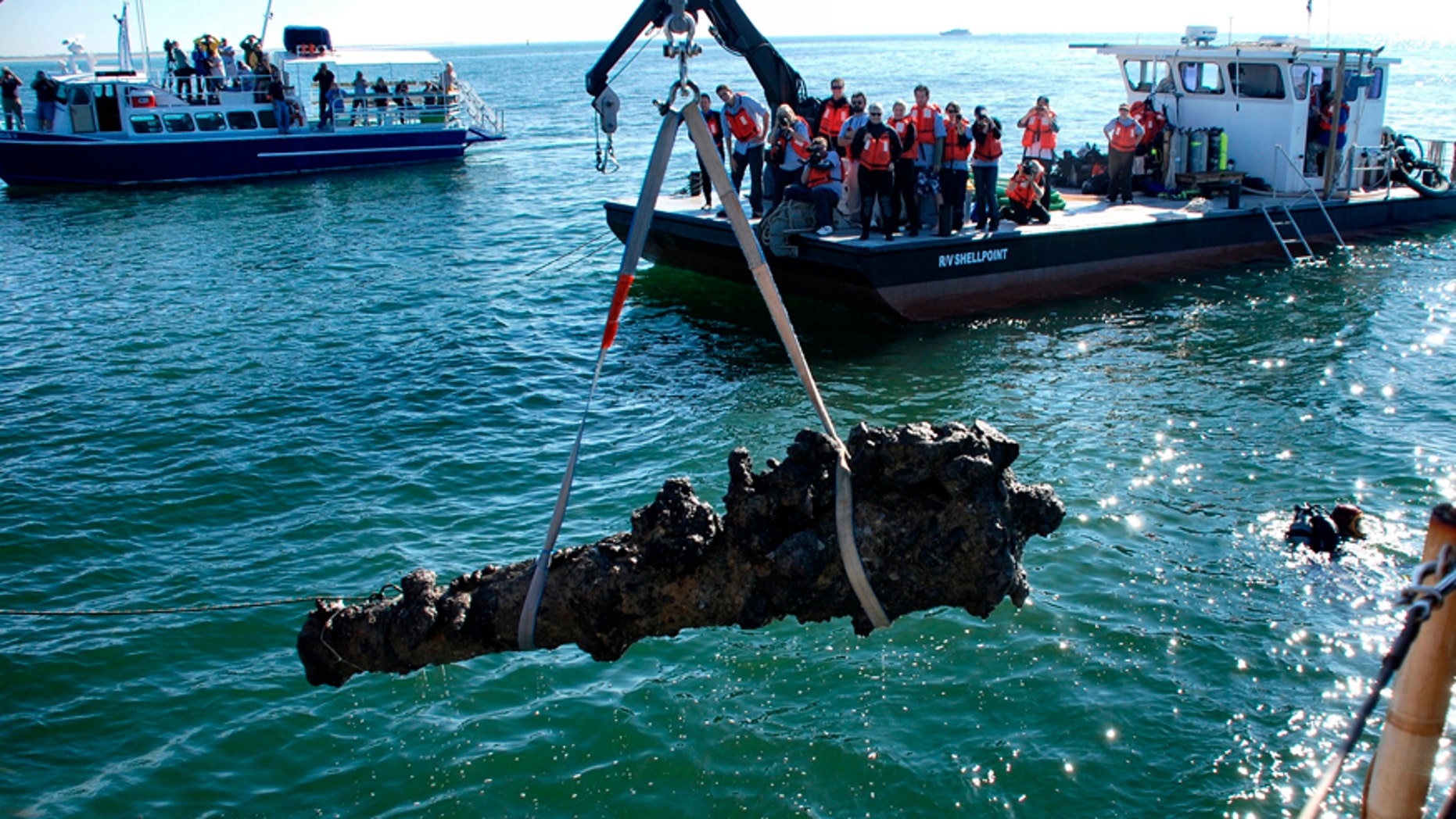 File photo - A one-ton cannon which was recovered from the Queen Anne's Revenge shipwreck site, is pulled from the water near Beaufort, North Carolina, Oct. 26, 2011.