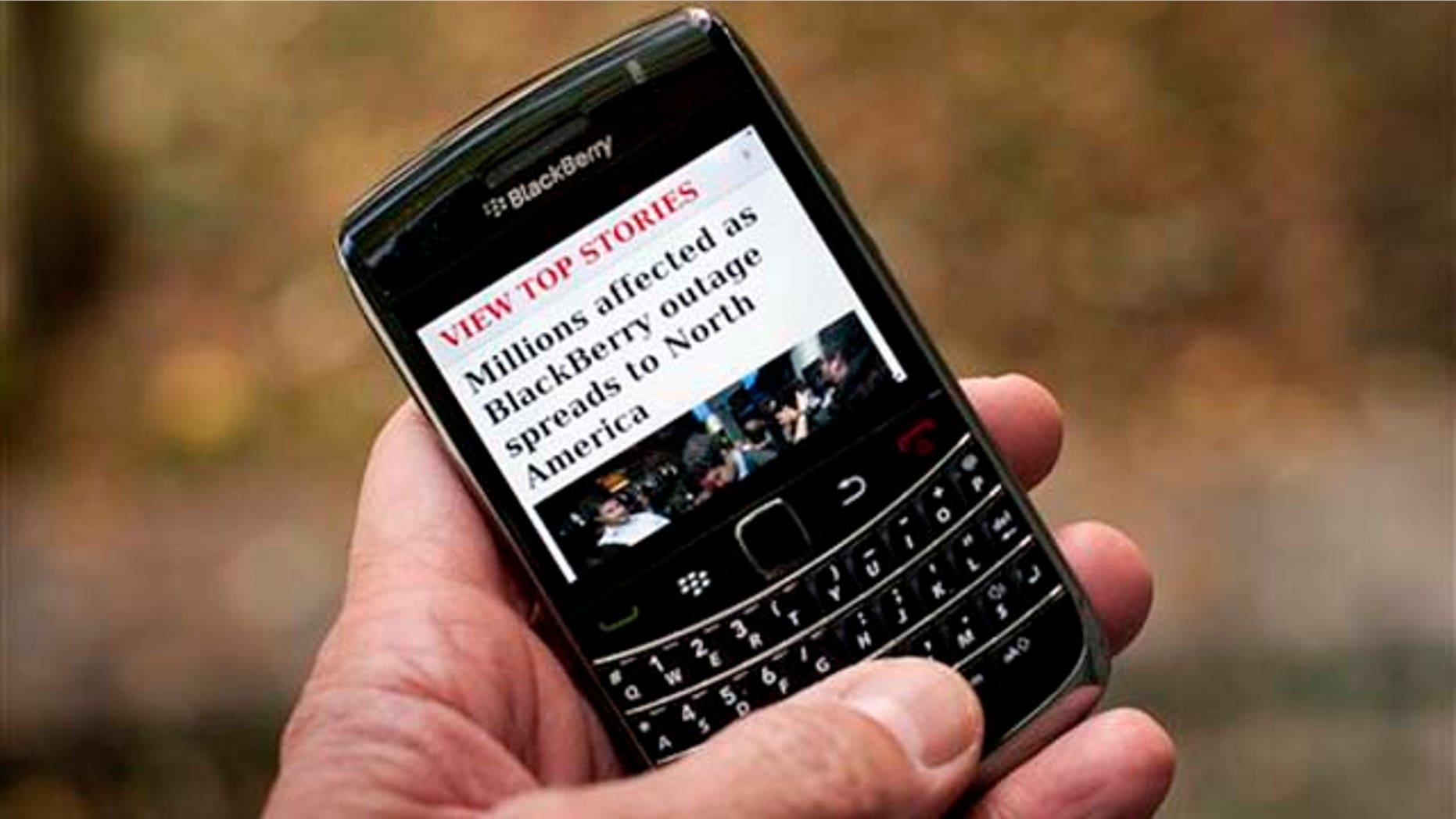 Oct. 12, 2011: A Blackberry user reads a story about a Blackberry outage that is affecting millions of users of the smartphone that has now spread to North America Wednesday in Montreal. Sporadic outages of BlackBerry messaging and email service spread to the U.S. and Canada on Wednesday, as problems stretched into the third day for Europe, Asia, Latin America and Africa.