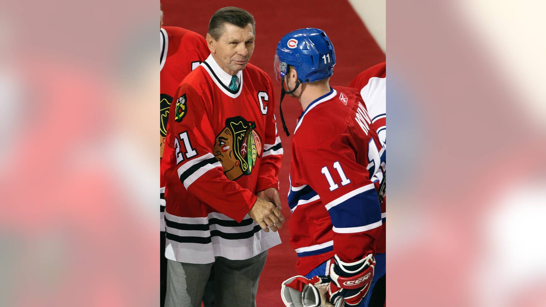 FILE - In this Jan. 8, 2008, file photo, Montreal Canadiens captain Saku Koivu (11) talks with Chicago Blackhawks great Stan Mikita during a pregame ceremony in Montreal. Mikita's family says the Blackhawks Hall of Famer has been diagnosed with a suspected brain disorder, adding that the 74-year-old is "facing some serious health issues" and has suspected Lewy body dementia. (AP Photo/The Canadian Press, Paul Chiasson, File)