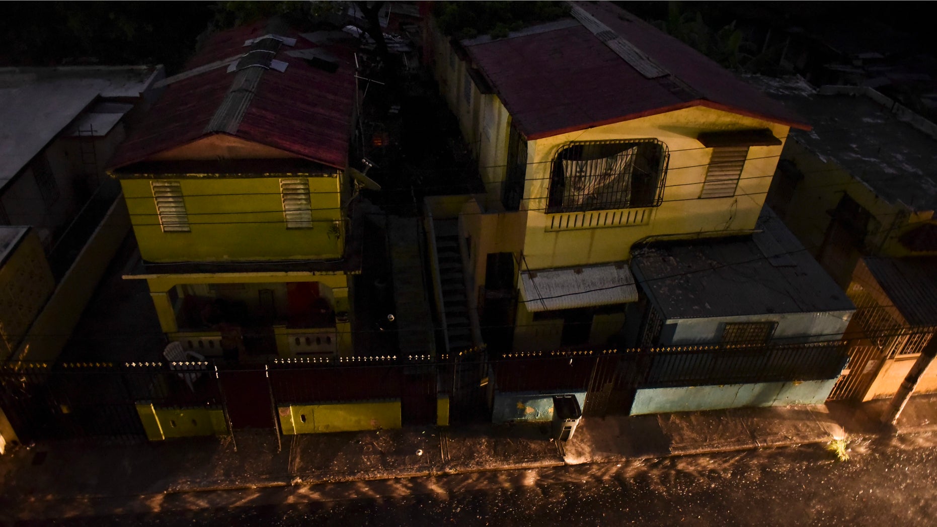 Vehicle lights illuminate a street after a massive blackout, in San Juan, Puerto Rico, Thursday, Sept. 22, 2016. Puerto Ricans faced another night of darkness Thursday as crews slowly restored electricity a day after a fire at a power plant caused the aging utility grid to fail and blacked out the entire island. (AP Photo/Carlos Giusti)