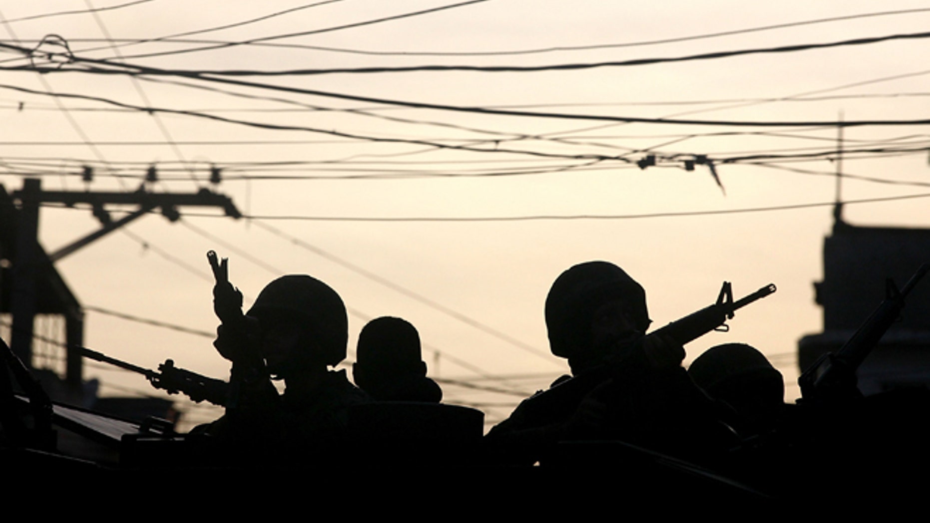 Brazilian soldiers keep watch in the unpacified Complexo da Maré, one of the largest 'favela' complexes in Rio de Janeiro, Brazil, on March 30, 2014.