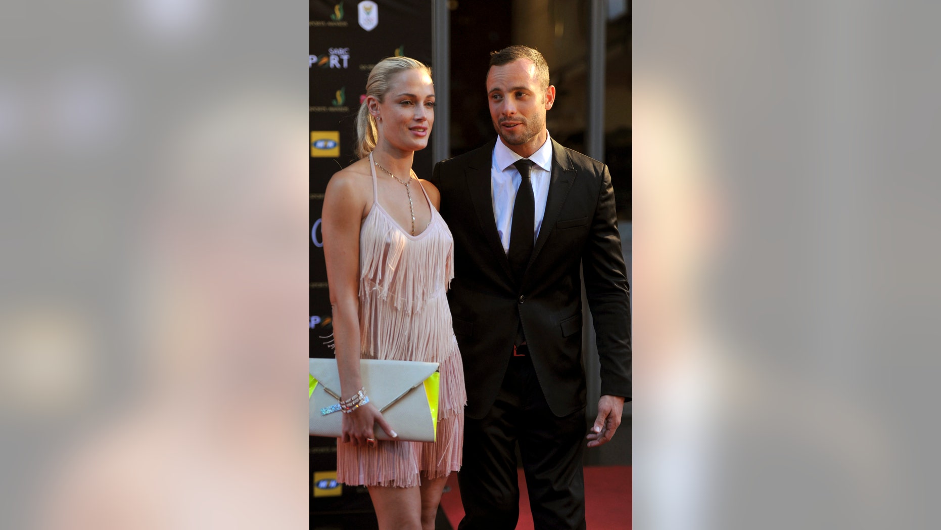 In this Nov. 4, 2012 photo, South African Olympic athlete Oscar Pistorius and Reeva Steenkamp, believed to be his girlfriend, at an awards ceremony, in Johannesburg, South Africa. Olympic athlete Oscar Pistorius was taken into custody and was expected to appear in court Thursday, Feb. 14, 2013, after a 30-year-old woman who was believed to be his girlfriend was shot dead at his home in South Africa's capital, Pretoria. (AP Photo/Lucky Nxumalo-Citypress) SOUTH AFRICA OUT
