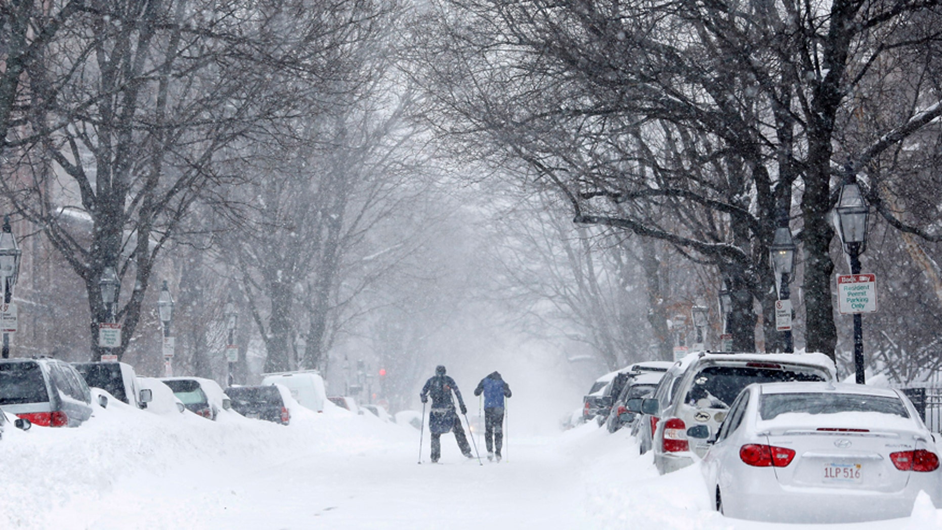 Two people cross-country ski up Marlborough Street during a blizzard in Boston, Massachusetts Jan. 27, 2015.