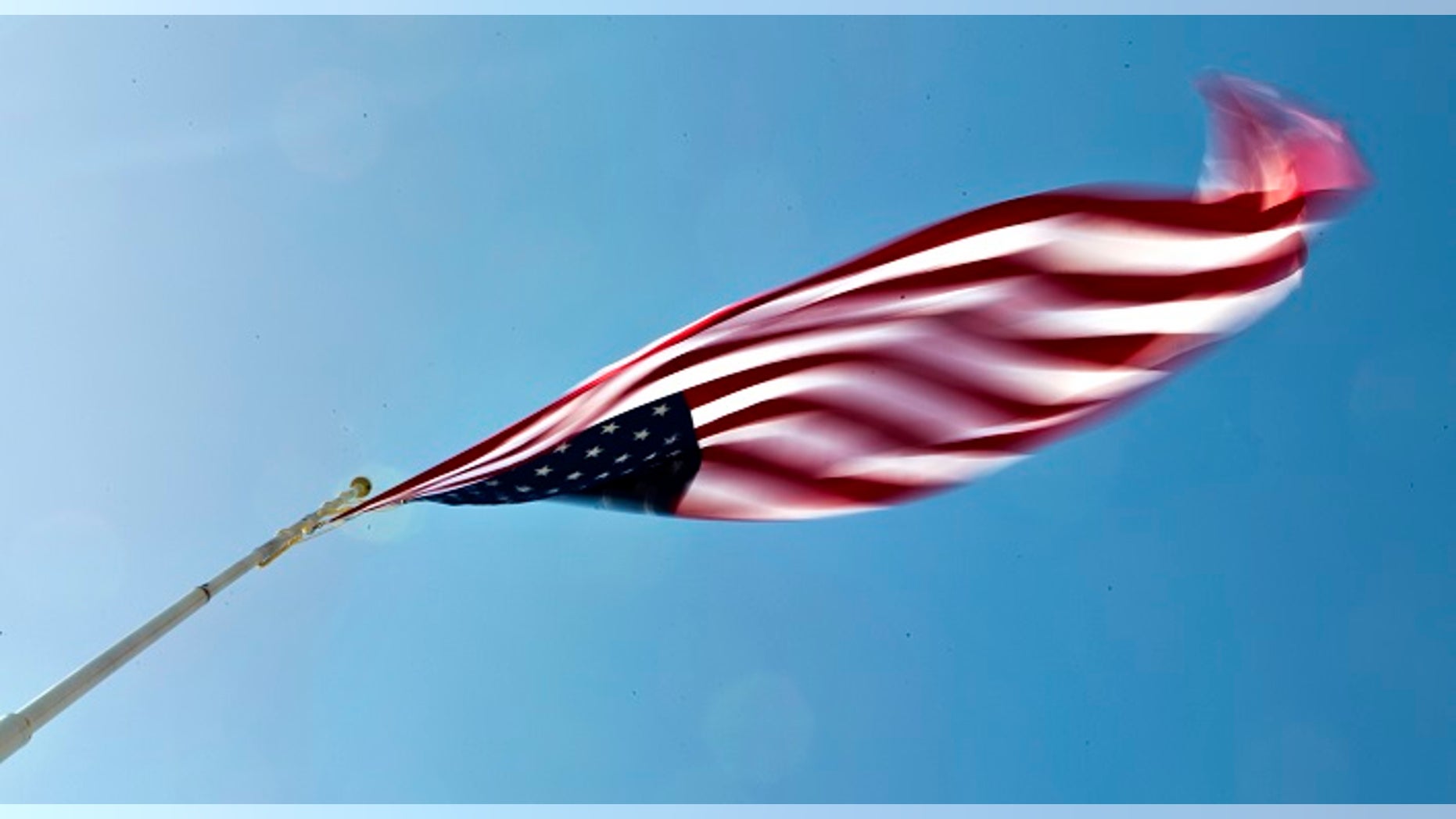 A large American flag blows wildly in the wind at the Terrible Herbst station in the Las Vegas area are predicted to go as high as 50 mph on Tuesday, April, 14, 2015.(L.E. Baskow/Las Vegas Sun via AP)