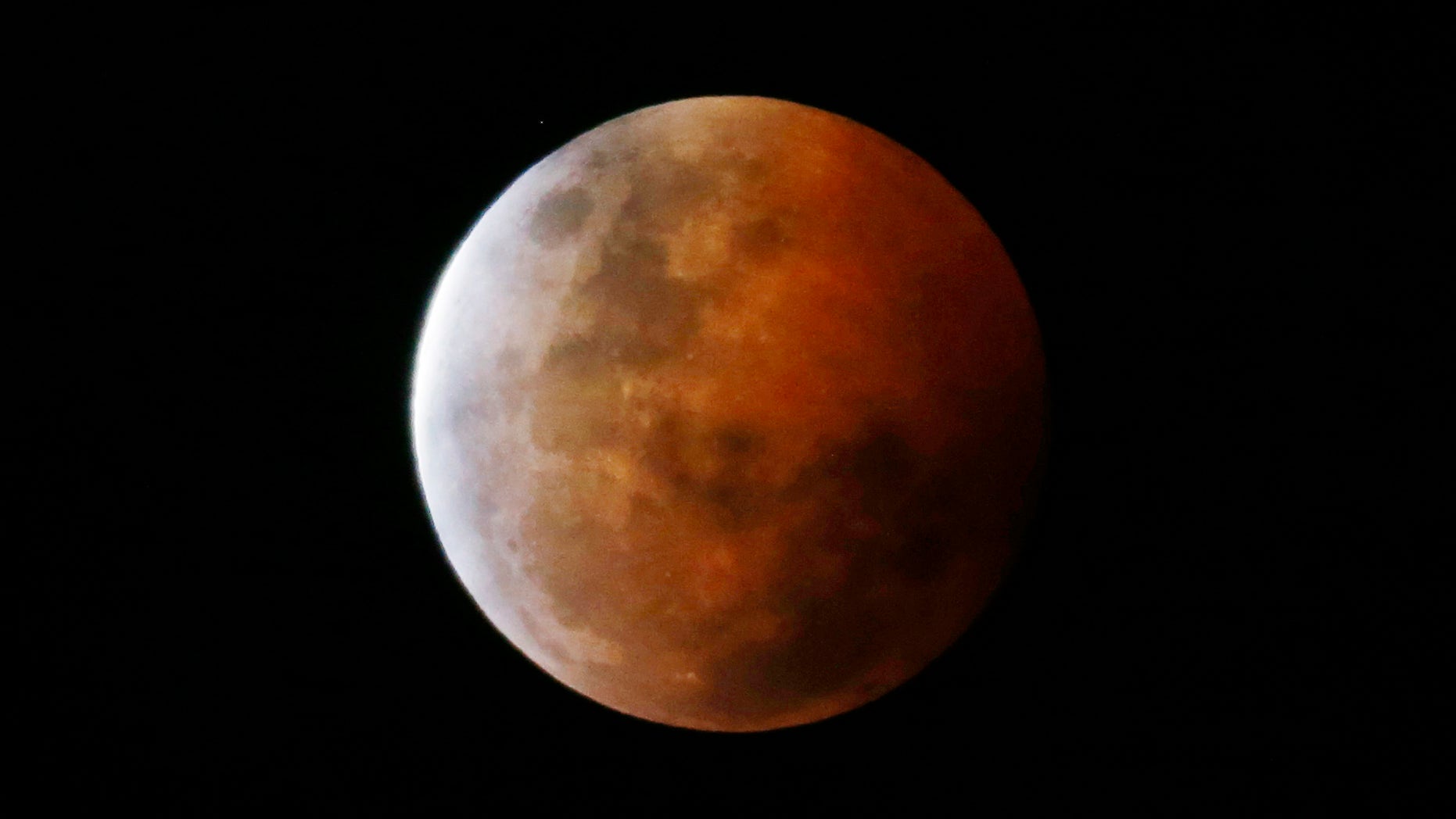 A total lunar eclipse, also known as a "blood moon", is pictured from Gosford, north of Sydney, Oct. 8, 2014.
