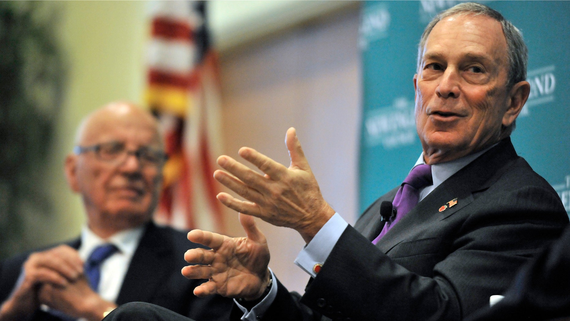 From left, News Corporation CEO Rupert Murdoch, looks on as New York Mayor Michael Bloomberg speaks during a forum on The Economics and Politics of Immigration in Boston on Tuesday.