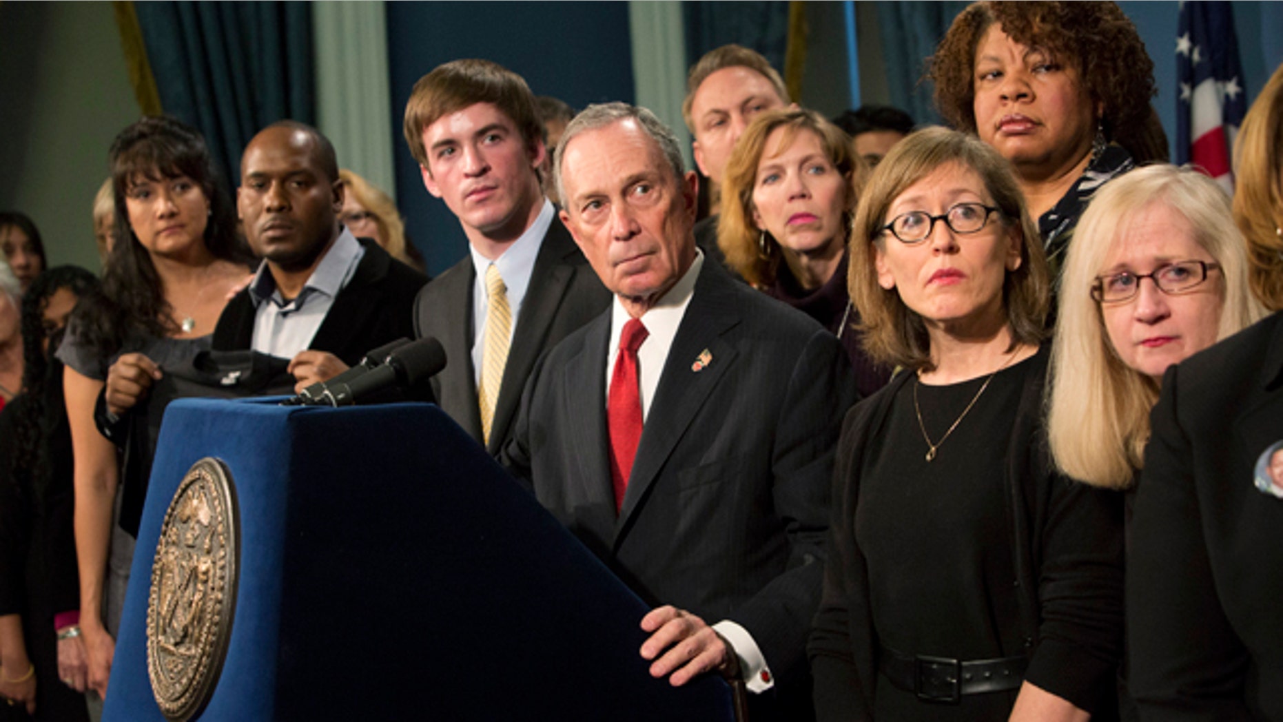 Dec. 17, 2012: New York City Mayor Michael Bloomberg (C), along with survivors and family members of gun violence victims, addresses the media as part of the Mayors Against Illegal Guns group.