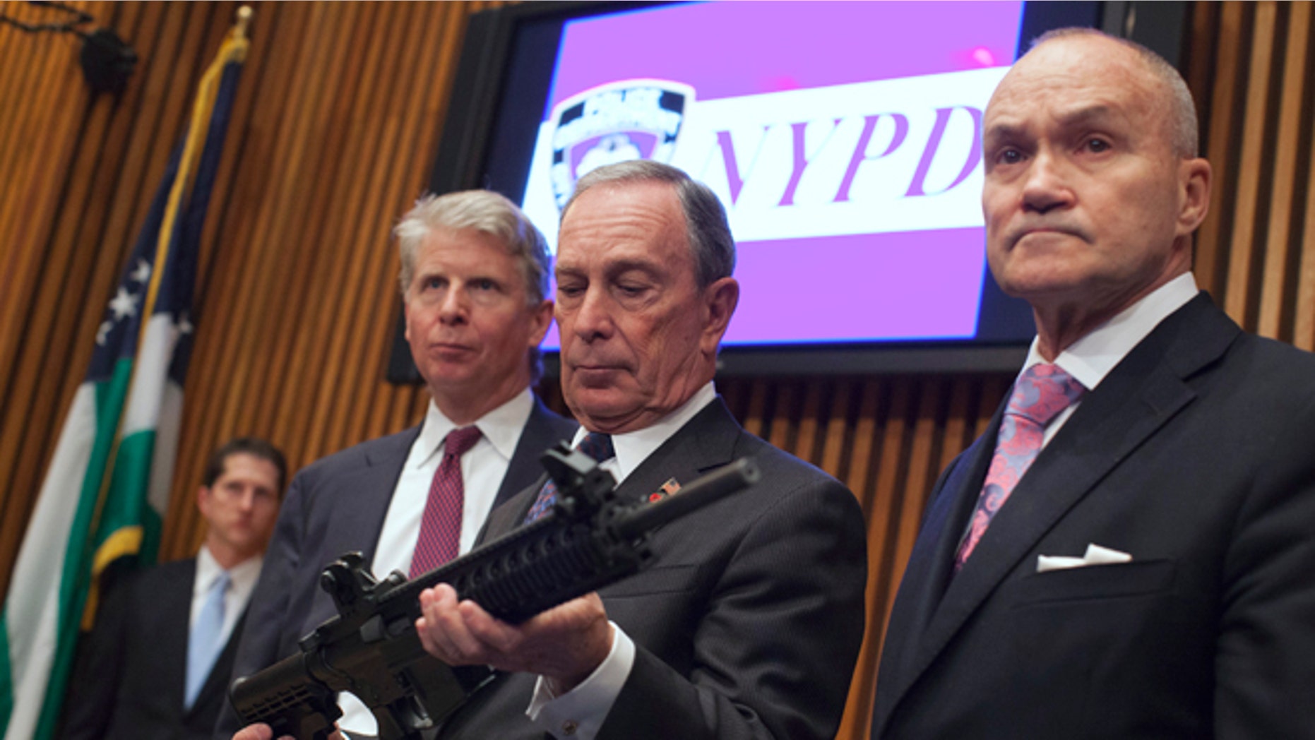 Oct. 12, 2012: Mayor Michael Bloomberg, center, examines a confiscated gun with Police Commissioner Ray Kelly, right, and District Attorney Cyrus Vance in New York. (Reuters)
