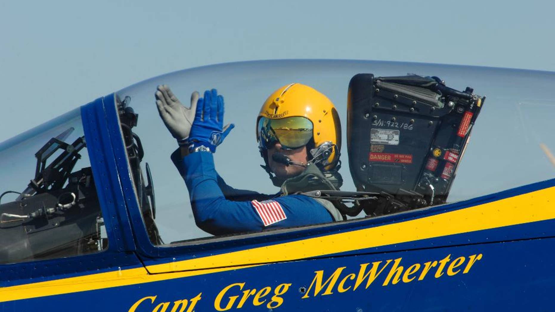 In this Sept. 10, 2011 photo provided by the U.S. Navy, Capt. Greg McWherter, commanding officer and flight leader of the U.S. Navy flight demonstration squadron, the Blue Angels, responds to the crowd at the Guardians of Freedom Air Show in Lincoln, Neb. The U.S. Navy says McWherter has been relieved of duty over misconduct while he was commanding officer of the Blue Angels. McWherter allegedly allowed and in some cases encouraged sexually explicit humor, lewd speech and inappropriate comments among the famed precision flying team. McWherter's most recent post was as executive officer of Naval Base Coronado. (AP Photo/U.S. Navy, Jen Blake)
