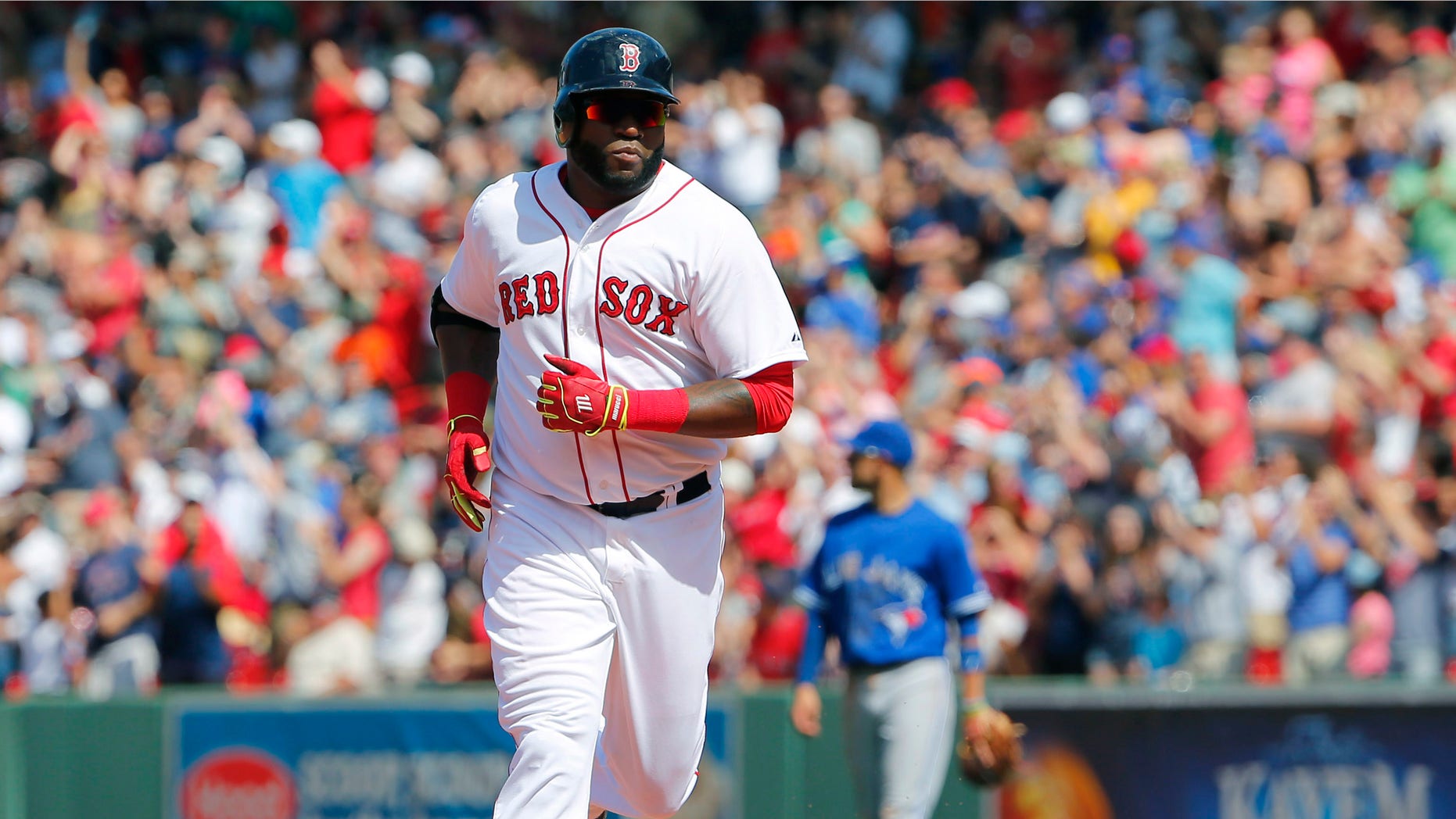 Boston Red Sox designated hitter David Ortiz rounds the bases after hitting a solo home run against the Toronto Blue Jays during the sixth inning of a baseball game at Fenway Park in Boston Saturday, June 13, 2015. (AP Photo/Winslow Townson)