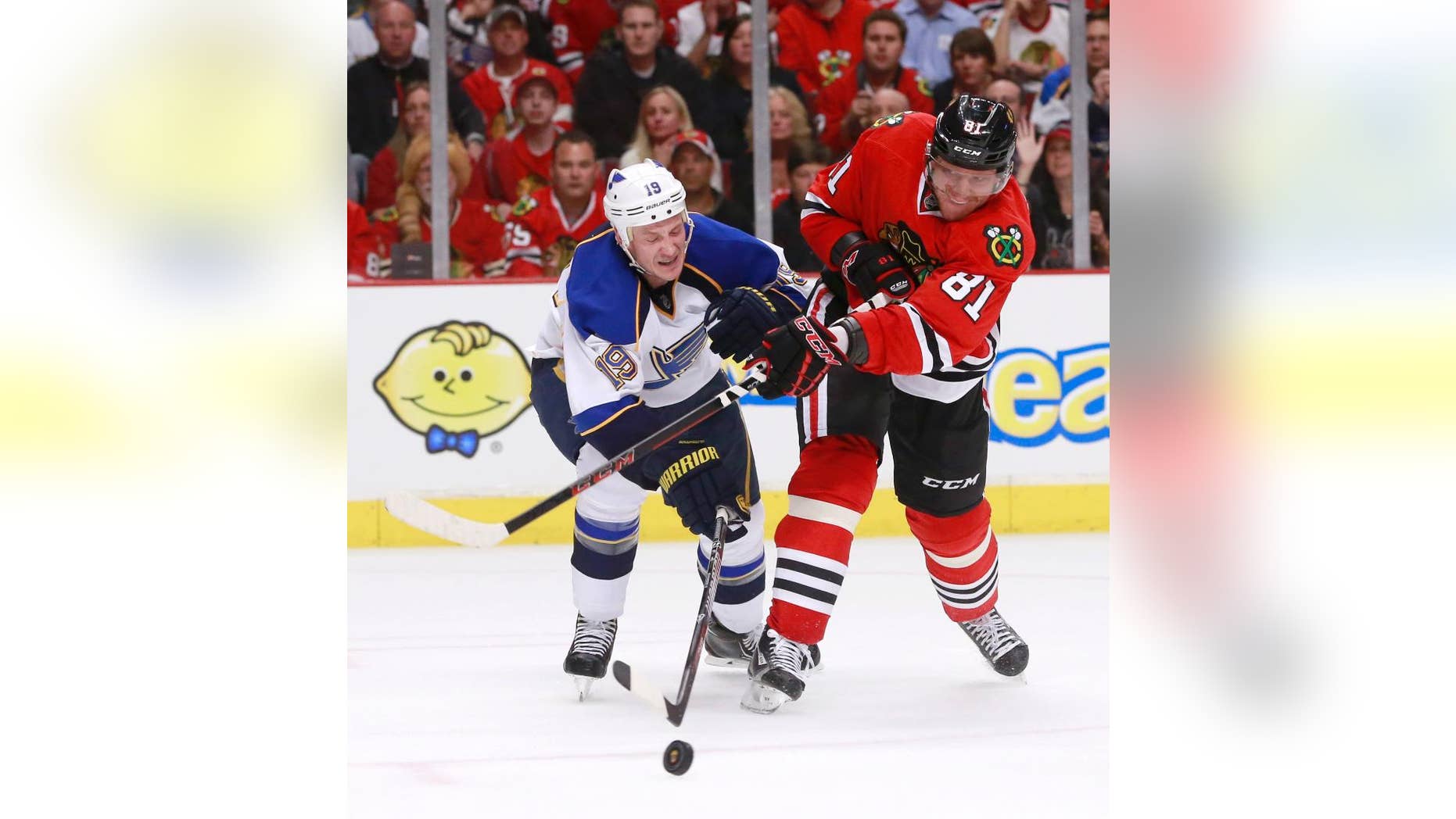 St. Louis Blues defenseman Jay Bouwmeester (19) deflects a shot by Chicago Blackhawks right wing Marian Hossa (81) during the second period in Game 3 of a first-round NHL hockey Stanley Cup playoff series game Monday, April 21, 2014, in Chicago. (AP Photo/Charles Rex Arbogast)