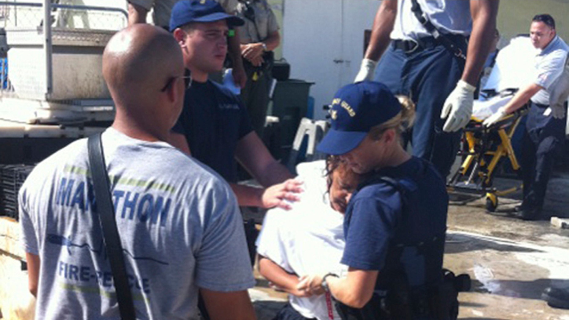 Oct. 9: Seaman Kendra Graves, right, and Petty Officer 3rd Class Robert Femia assist EMS personnel in Marathon, Fla., with one of seven boaters rescued after treading water for around 20 hours after the boat capsized and sank.