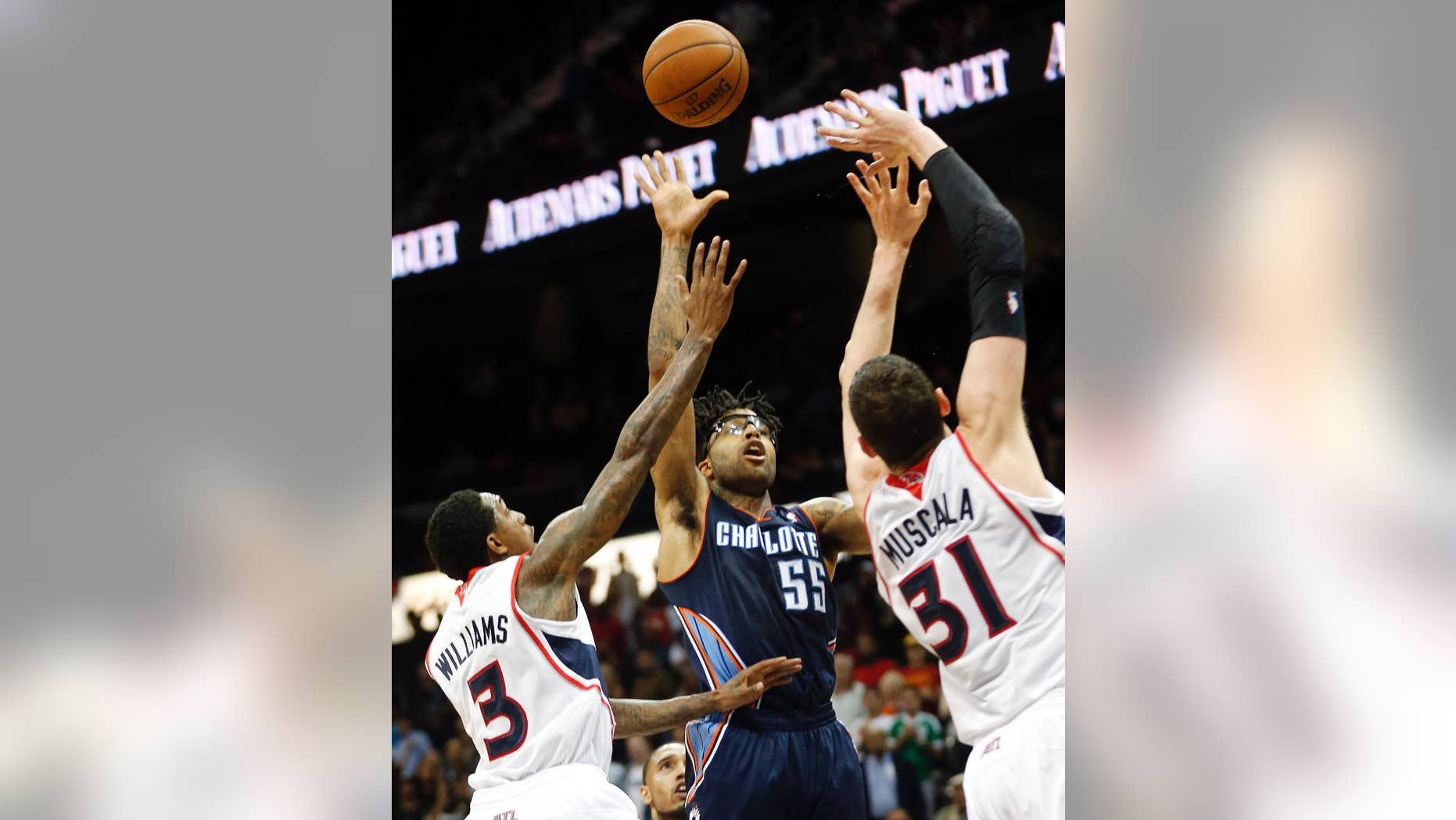 FILE - In this April 14, 2014 file photo, Charlotte Bobcats guard Chris Douglas-Roberts (55) hits the game-winning shot against Atlanta Hawks' Louis Williams (3) and Mike Muscala (31) as time expires in the second half of an NBA basketball game in Atlanta. Douglas-Roberts has gone from being a midseason D-League pickup to an important player for the Bobcats, particularly in the fourth quarter.(AP Photo/John Bazemore, File)