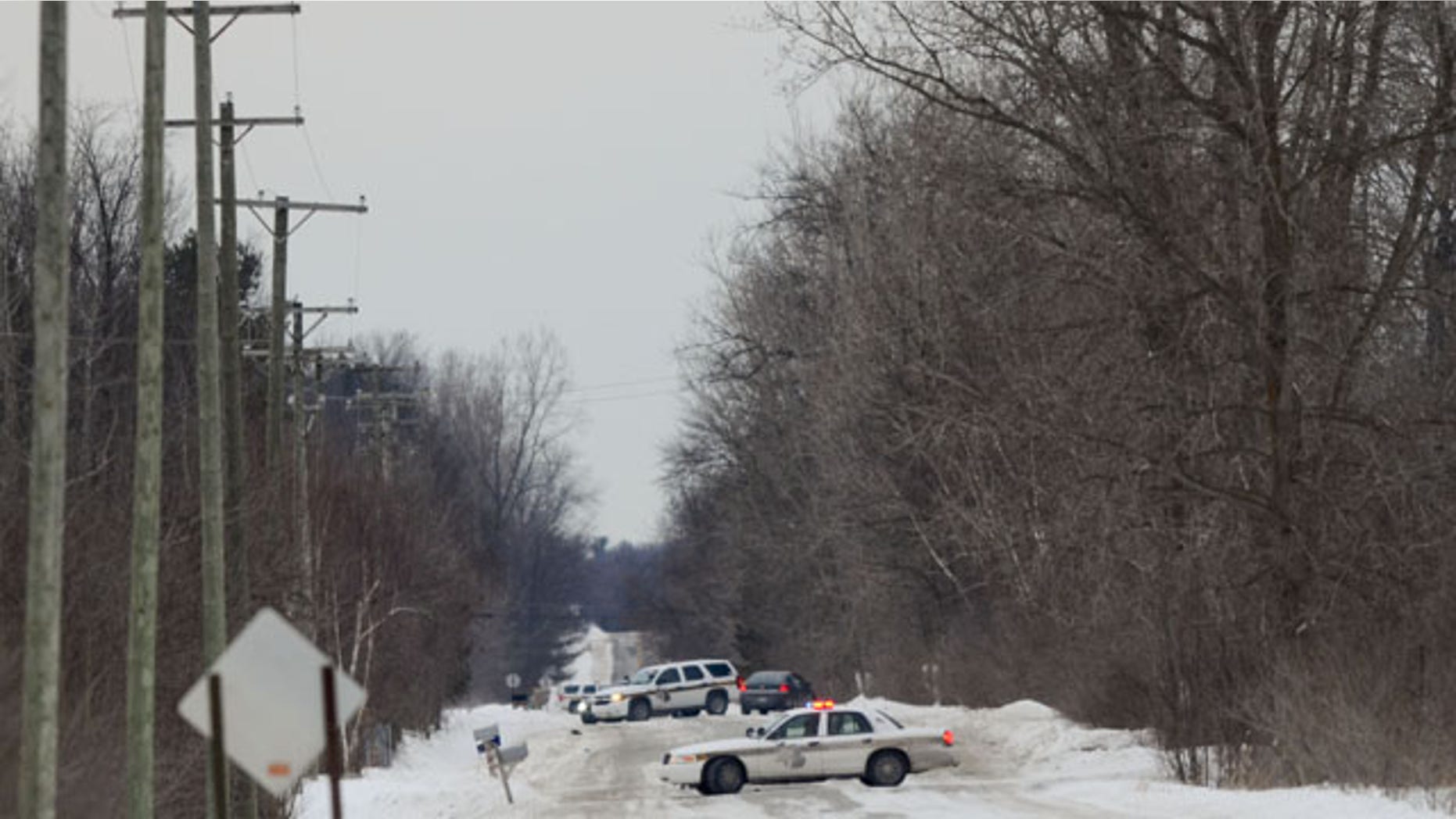 January 30, 2014: Officers from the St. Clair County Sheriff's Department investigate a scene where bags of human remains were discovered at the intersection Allington and Fred Moore Highway in St. Clair Township, Mich. (AP PHOTO/TIMES HERALD, JEFFREY SMITH)