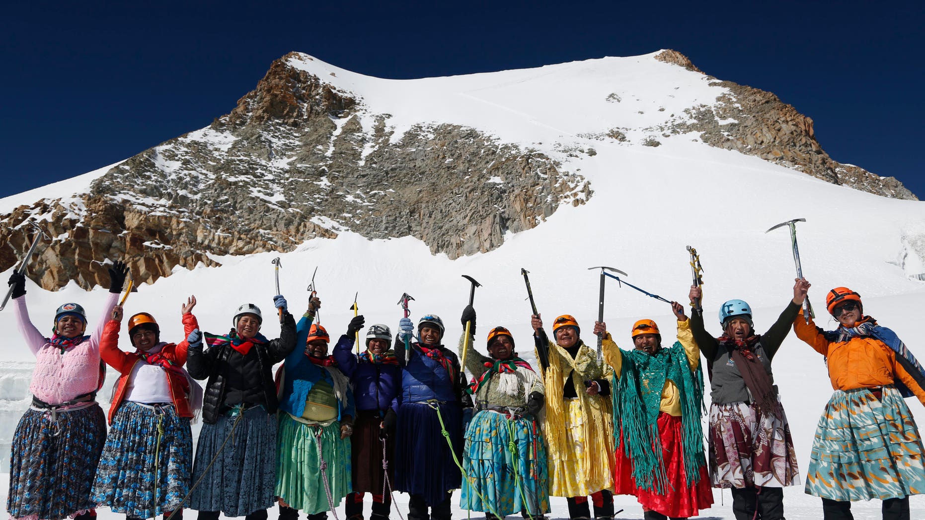 In this Dec. 16, 2015 photo, Aymara indigenous women pose for a picture as they reach the peak of the Huayna Potosi mountain on the outskirts of El Alto, Bolivia. From left are Cecilia Llusco, Juana Rufina Llusco Alana, Janet Mamani Callisaya, Domitila Alana Llusco, Marga Alana Llusco, Virginia Quispe Colque, Pacesa Llusco Alana, Lidia Huayllas, Bertha Vetia, Dora Magueno and Ana Gonzales. (AP Photo/Juan Karita)