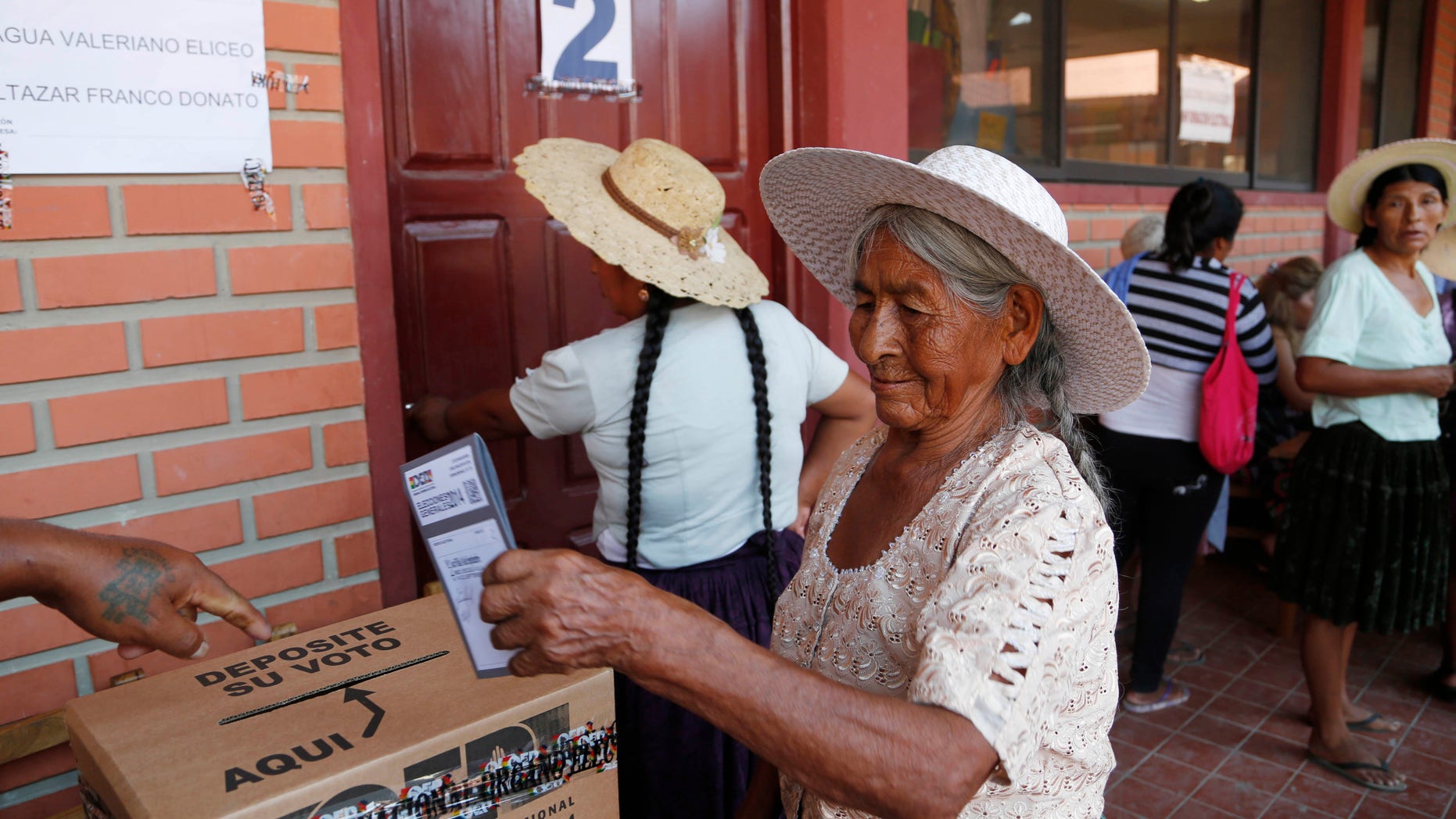 A woman casts her ballot at a polling station in Villa 14 de Septiembre, in the Chapare region, Bolivia, Sunday, Oct. 12, 2014. Bolivia is holding general and presidential elections Sunday with President Evo Morales appearing to be headed to an unprecedented third term.(AP Photo/Juan Karita)