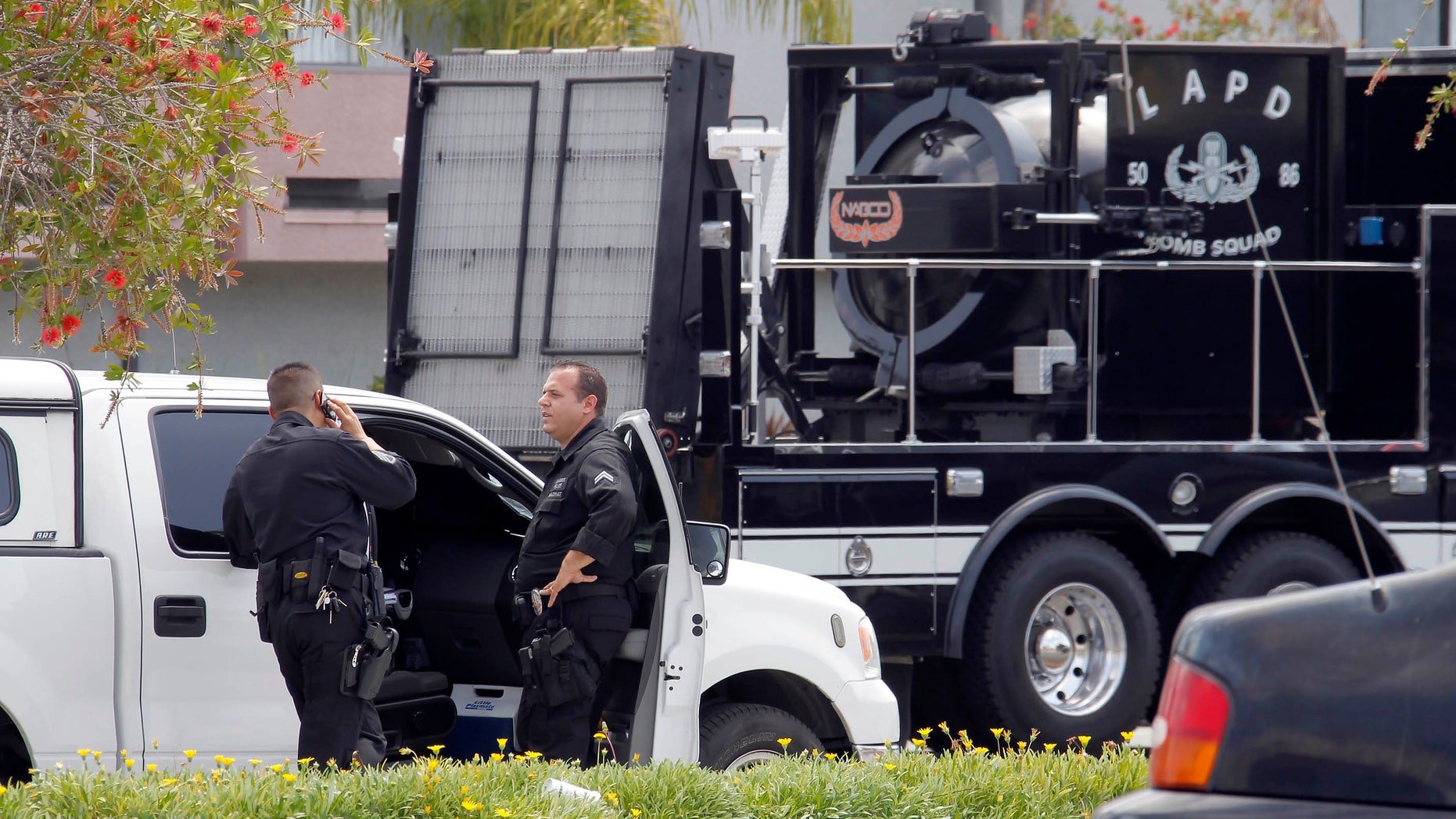 May 15, 2013: Los Angeles Police Department bomb squad officers gather at the site where police arrested a man after discovering explosive material in his car and potential explosive devices in his apartment.