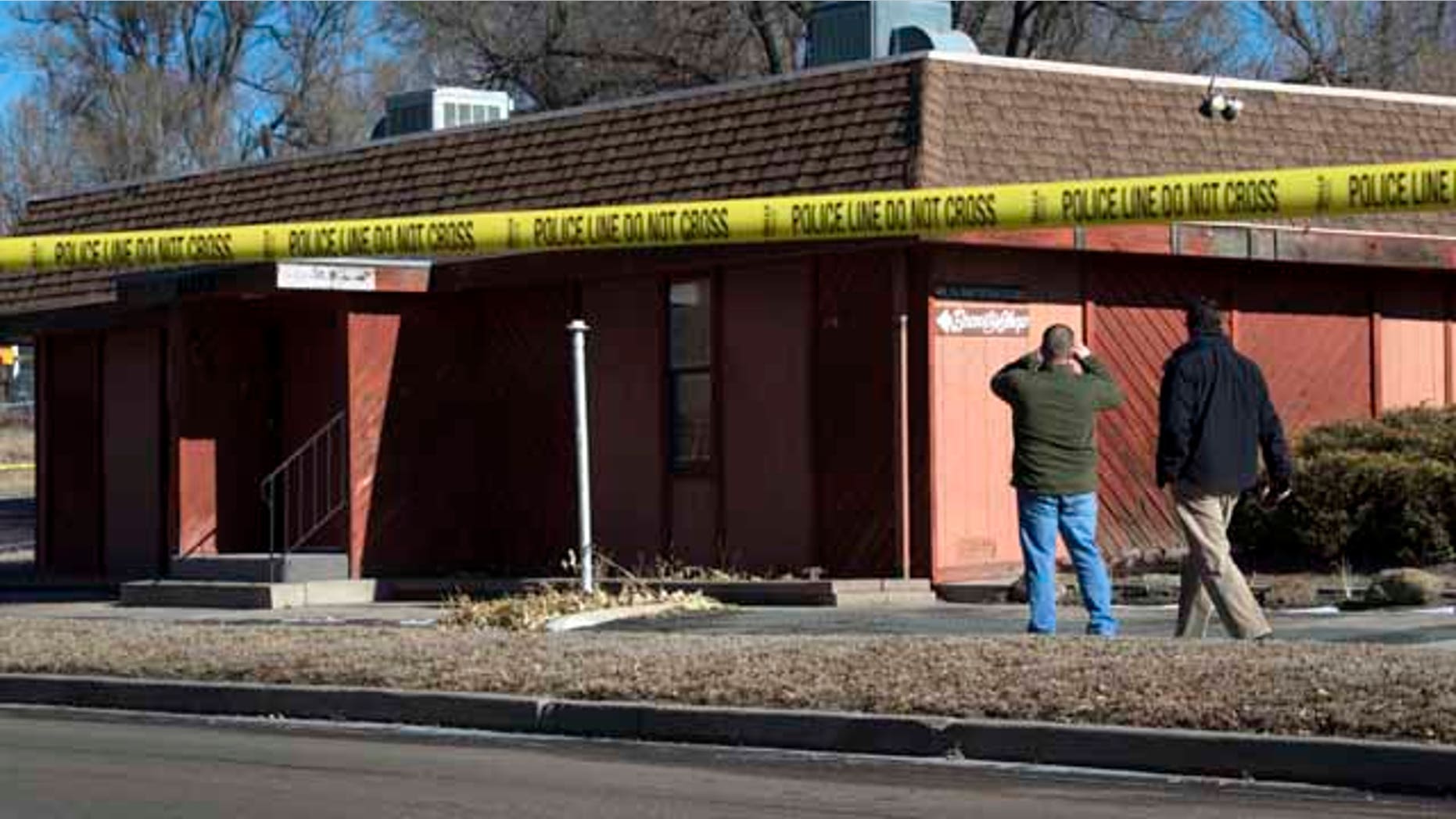 Jan. 6, 2015: Colorado Springs police officers investigate the scene of an explosion. (AP Photo/The Colorado Springs Gazette, Christian Murdock)