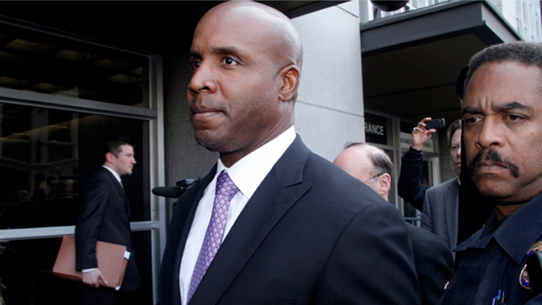 FILE - In this April 13, 2011, file photo, former baseball player Barry Bonds leaves federal court in San Francisco, after being found guilty of one count of obstruction of justice. (AP Photo/George Nikitin, File)