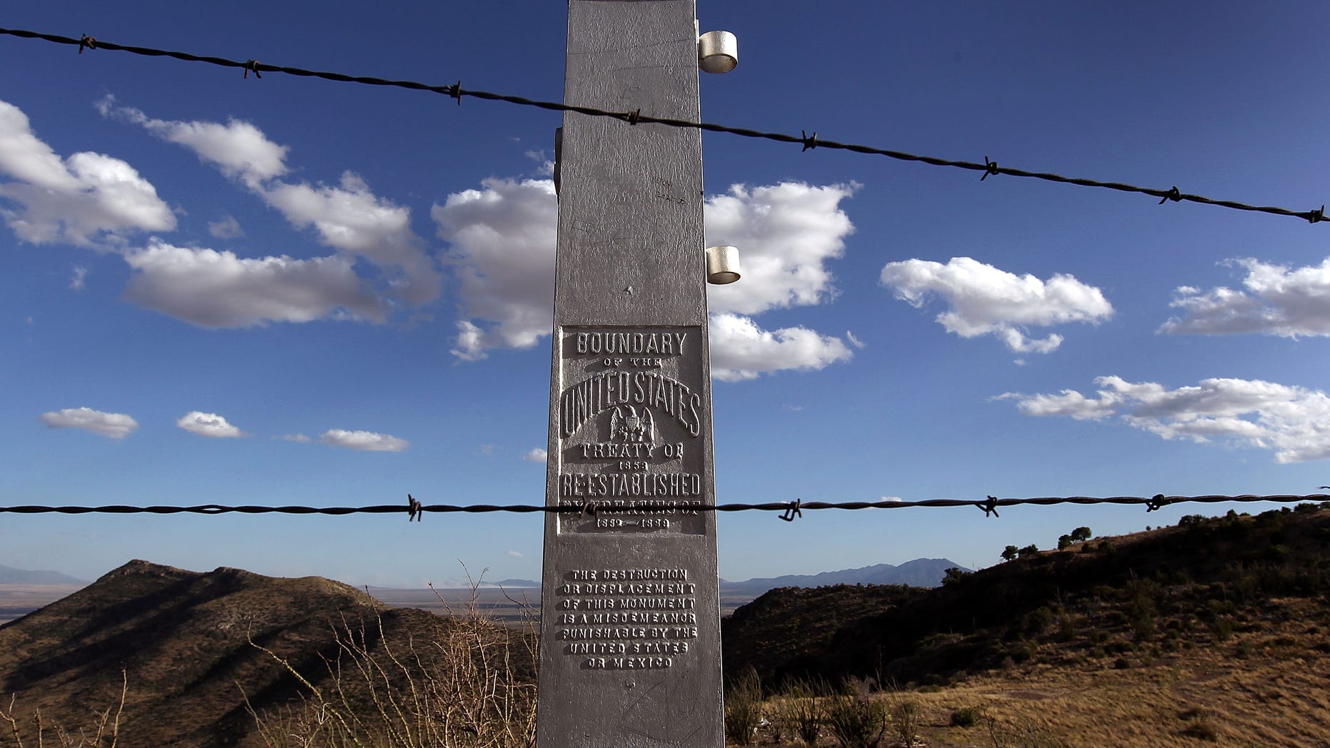 MONTEZUMA PASS, AZ - MAY 02: An obelisk and a barbed wire fence mark the border between the United States and Mexico on May 2, 2010 at Montezuma Pass, Arizona. Although the U.S. government has spent billions of dollars constructing border defenses in the last decade, critics say that Arizona's border with Mexico was left with less protection, compared with California and Texas. Proponents of Arizona's new immigration enforcement law say that federal inaction led to passage of the law, which has raised fears of racial profiling by police against Latinos. (Photo by John Moore/Getty Images)