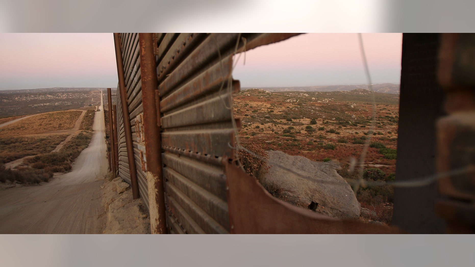 CAMPO, CA - JULY 29: A hole has been cut in the US-Mexico border fence where Border Patrol agents are carrying out special operations following the first fatal shooting of a US Border Patrol agent in more than a decade on July 29, 2009 near the rural town of Campo, some 60 miles east of San Diego, California. 30-year-old agent Robert Rosas was killed on July 23 when he tracked a suspicious group of people alone in remote brushy hills north of the border in this region. Violence has been escalating in Mexico with fights between well-armed drug cartels and the army becoming common since Mexican President Felipe Calderon began his army-backed war on the cartels. Since the conflict began in late 2006, 12,800 people have been killed. Mexican officials charge that guns which are easily smuggled in from the US have flooded into Mexico where gun laws are strict. (Photo by David McNew/Getty Images)