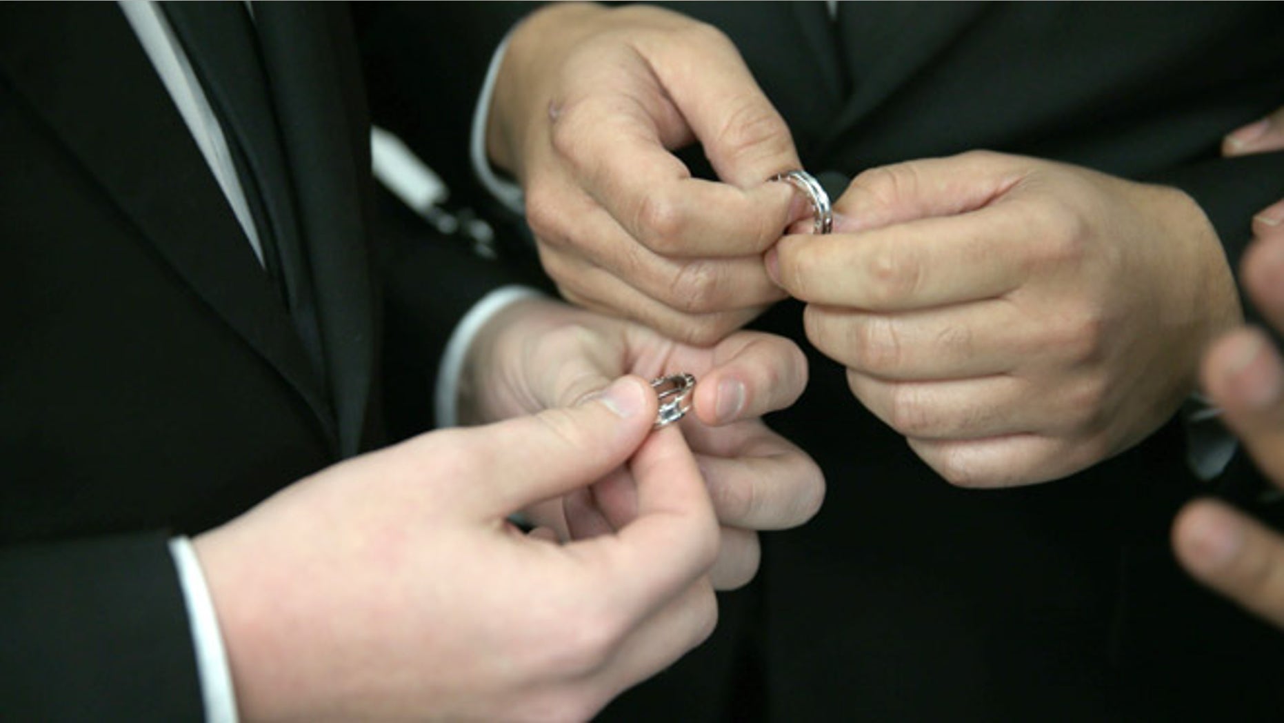 FORT LAUDERDALE, FL - JANUARY 06: A couple exchange rings as they are wed during a wedding ceremony at the Broward County Courthouse on January 6, 2015 in Fort Lauderdale, Florida. Gay marriage is now legal statewide after the courts ruled that the ban on gay marriage is unconstitutional and the Supreme Court declined to intervene. (Photo by Joe Raedle/Getty Images)