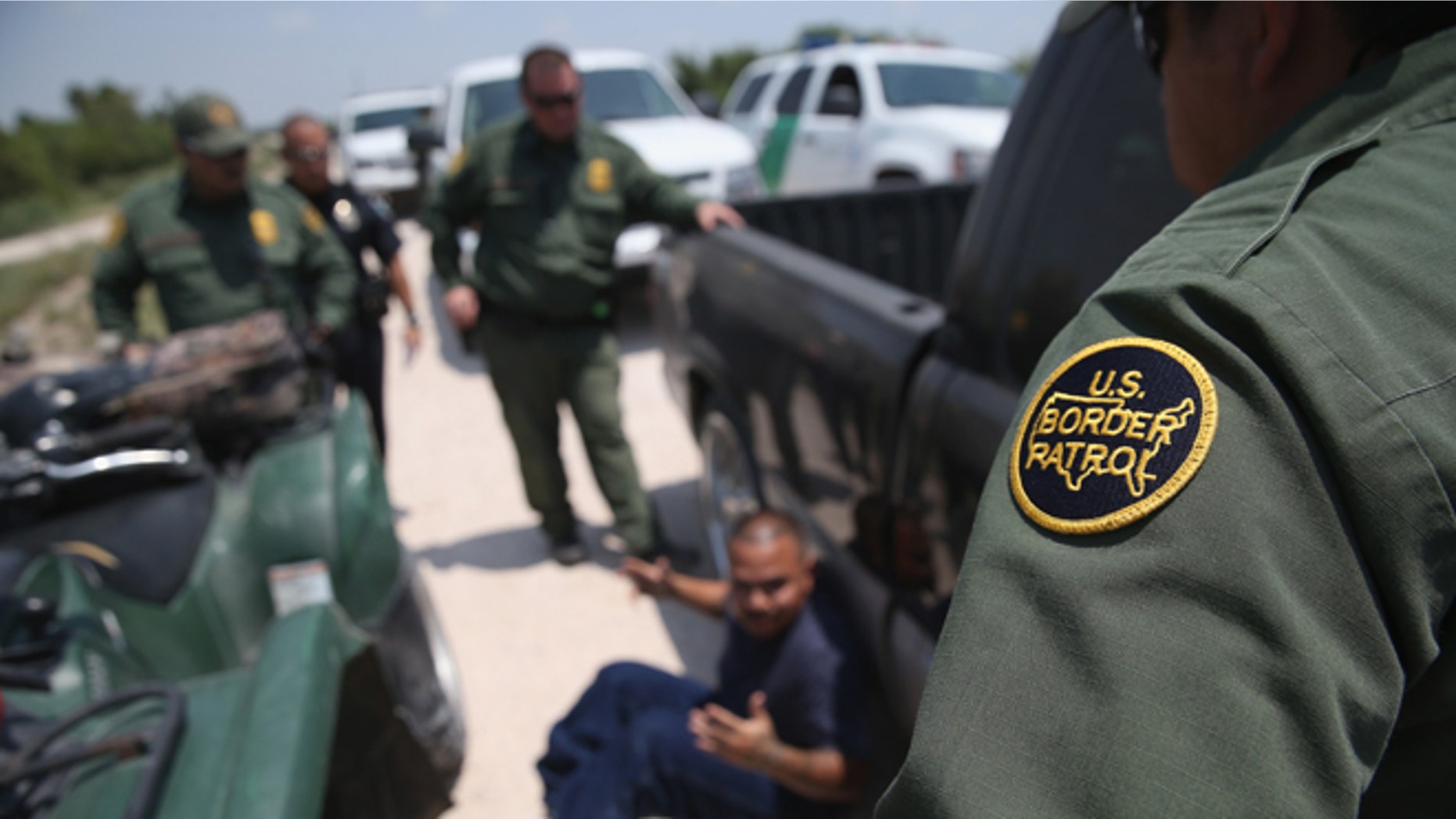 MISSION, TX - JULY 24: U.S. Border Patrol agents detain a suspected smuggler after he allegedly transported undocumented immigrants who crossed the Rio Grande from Mexico into the United States on July 24, 2014 in Mission, Texas. Tens of thousands of undocumented immigrants, many of them unaccompanied minors, have crossed illegally into the United States this year and presented themselves to federal agents, causing a humanitarian crisis on the U.S.-Mexico border. (Photo by John Moore/Getty Images)