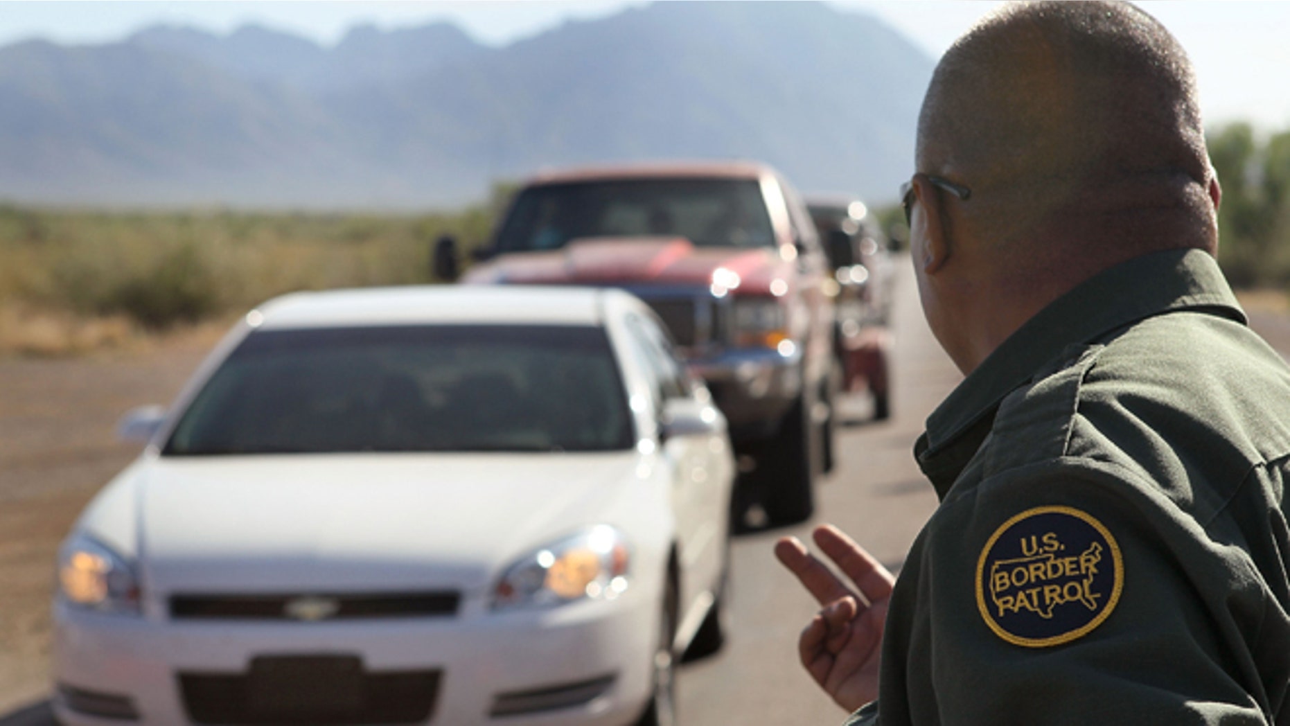 A Border Patrol agent checks vehicles for illegal immigrants and contraband at a roadside checkpoint June 1, 2010 near Sasabe, Arizona. (Photo by Scott Olson/Getty Images)