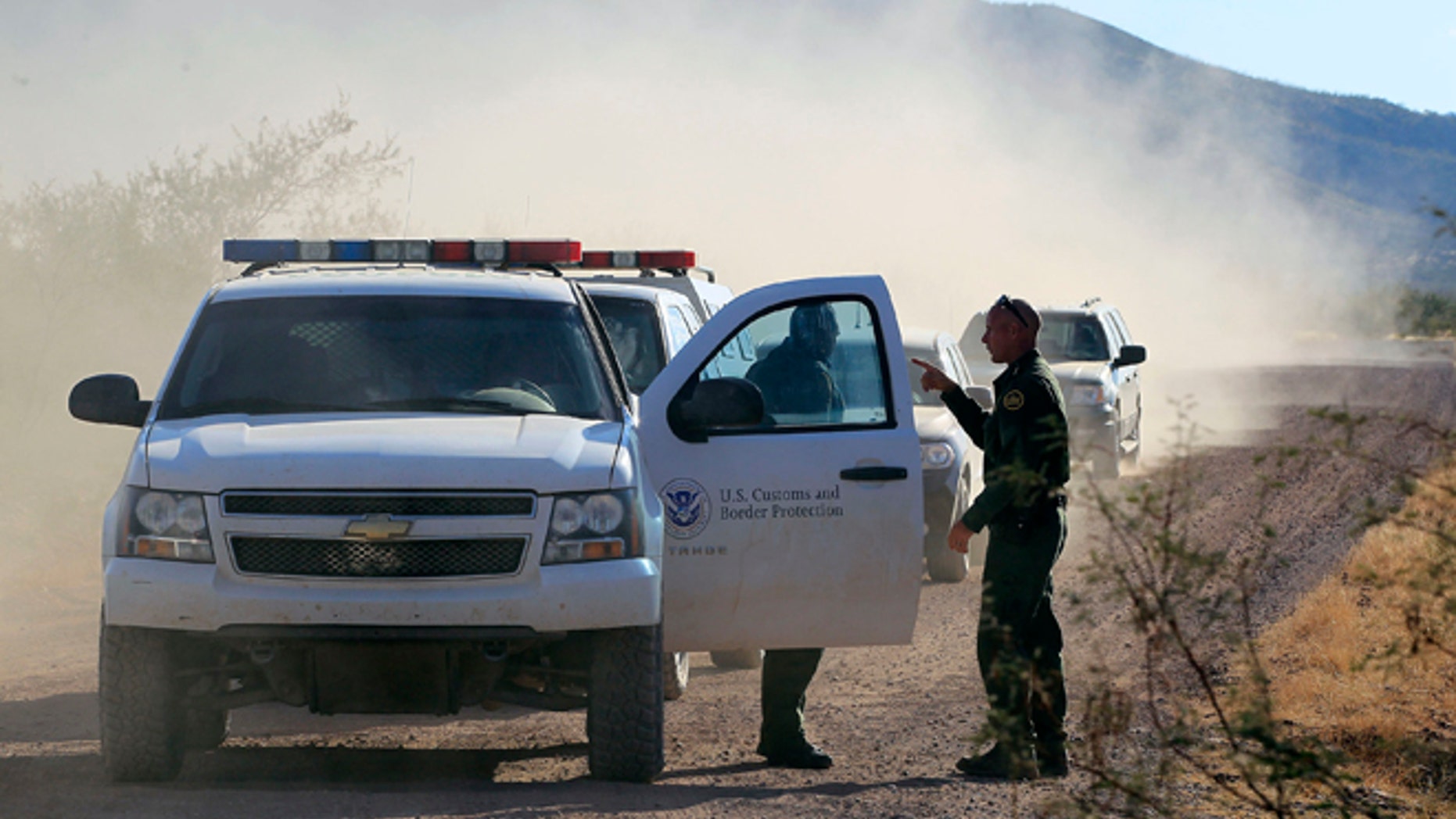 FILE - In this Oct. 2, 1012 file photo, U.S. Customs and Border Protection officers and other law enforcement jurisdictions drive the roads near near Bisbee, Ariz. New Homeland Security Secretary Jeh Johnson is reviewing the departmentâs use of force policies, a Homeland Security official said Friday. The official said Johnson has been reviewing the rules about when agents along the border can use their guns since he took office in December. (AP Photo/Ross D. Franklin, file)