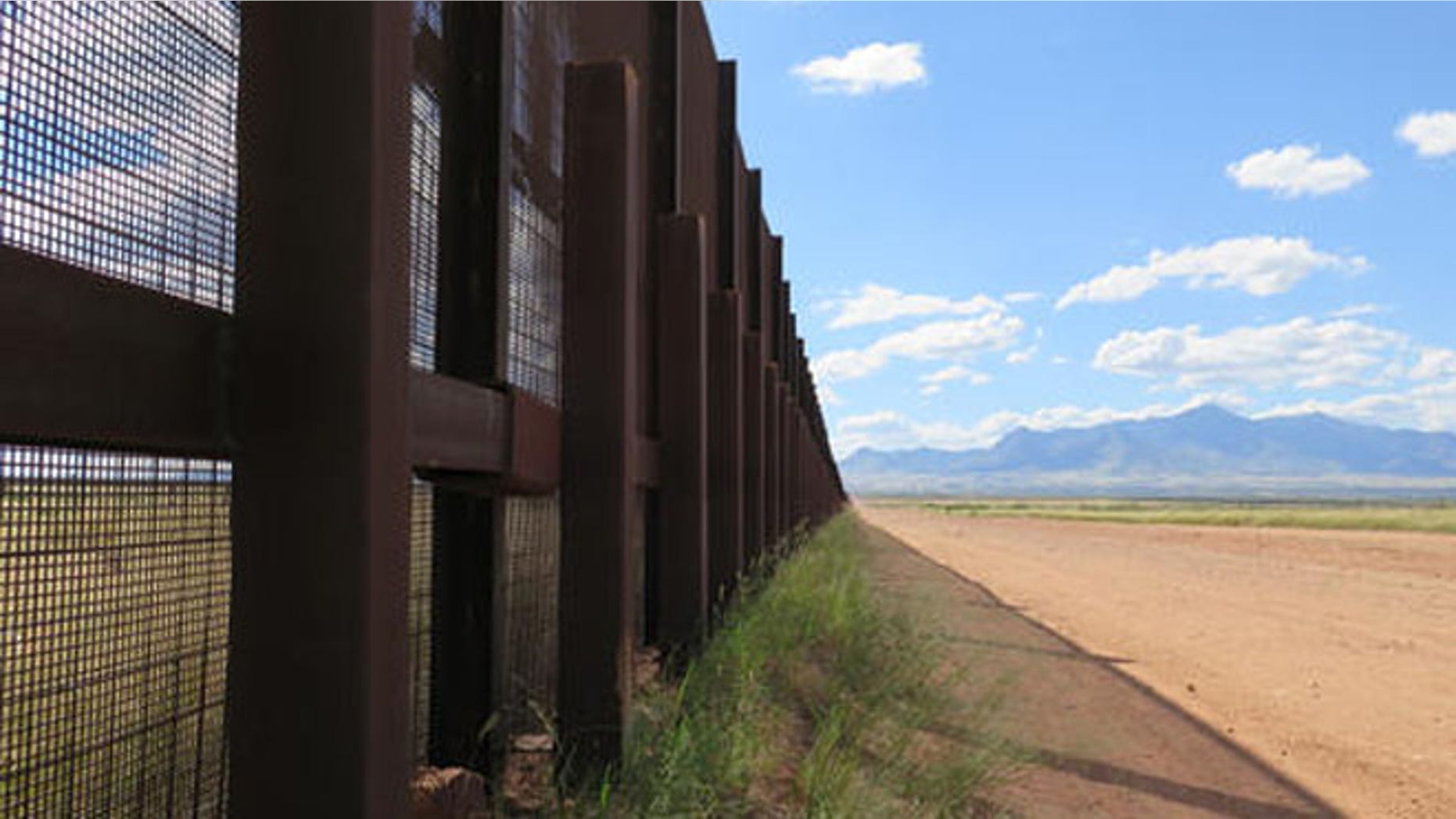 This Wednesday, Sept. 16, 2015 photo shows a part of the border fence near Naco, Ariz., during a tour of the border hosted by the Cochise County Sheriff's Office. Ranchers in this area say the border needs a wall to keep out drug smugglers and illegal border crossers. (AP Photo/Astrid Galvan)