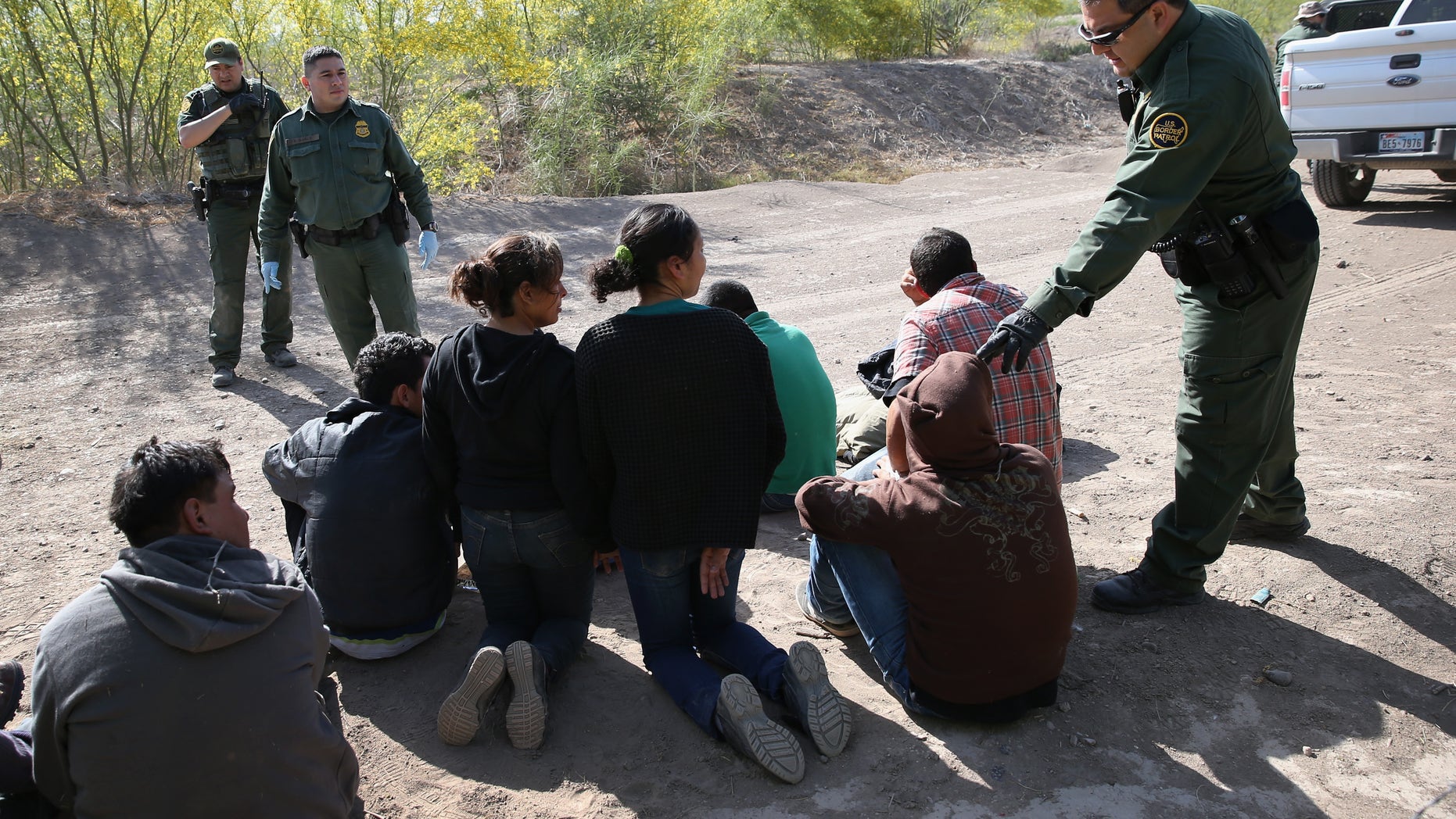 MISSION, TX - APRIL 11: U.S. Border Patrol agents detain undocumented immigrants near the U.S.-Mexico border on April 11, 2013 near Mission, Texas. A group of 16 immigrants from Mexico and El Salvador said they crossed the Rio Grande River from Mexico into Texas during the morning hours before they were caught. The Rio Grande Valley sector of has seen more than a 50 percent increase in illegal immigrant crossings from last year, according to the Border Patrol. Agents say they have also seen an additional surge in immigrant traffic since immigration reform negotiations began this year in Washington D.C. Proposed refoms could provide a path to citizenship for many of the estimated 11 million undocumented workers living in the United States. Photo by John Moore/Getty Images) (Photo by John Moore/Getty Images)