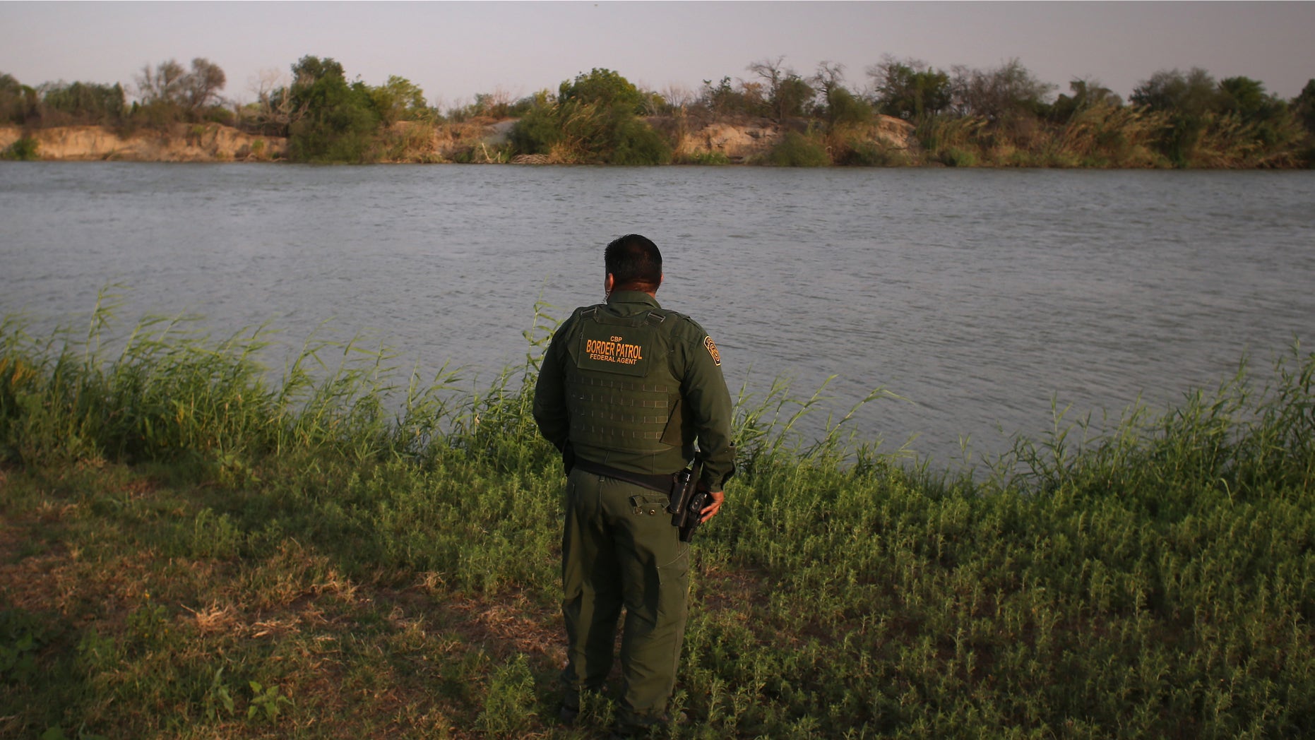 MCALLEN, TX - APRIL 10: U.S. Border Patrol agent Sal De Leon looks across the Rio Grande River into Mexico at the U.S.-Mexico border while on patrol on April 10, 2013 in McAllen, Texas. (Photo by John Moore/Getty Images)