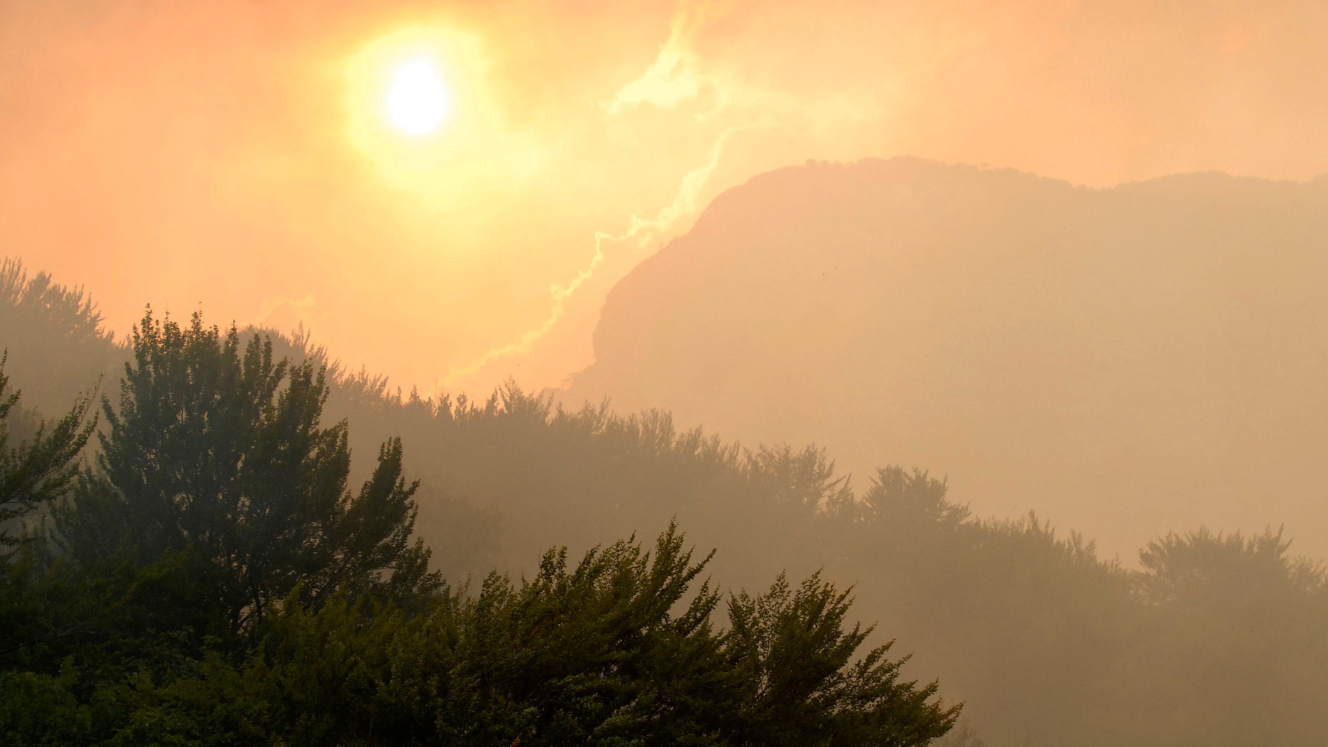 View from the Bosnian military helicopter of the sunset on the hills hit by a wildfires near the village Glogosnica, 70kms south of Sarajevo, Bosnia on Thursday Aug. 30. 2012. Bosnian military helicopter helps fighting the raging wildfires in the southern Bosnian region as the area has been hit by record high temperatures and no rain. (AP Photo/Sulejman Omerbasic)