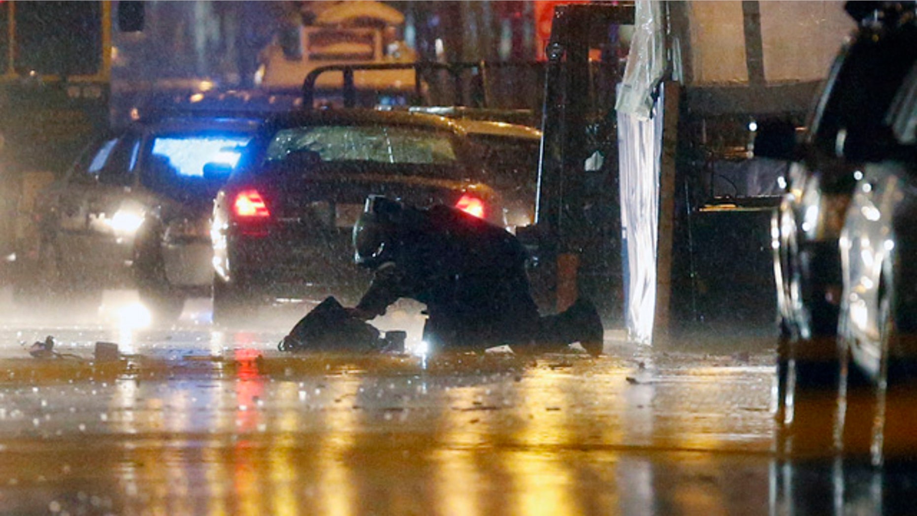 April 15, 2014: A member of the bomb squad inspects an object after a controlled detonation at the finish line of the Boston Marathon. (AP Photo/Michael Dwyer)