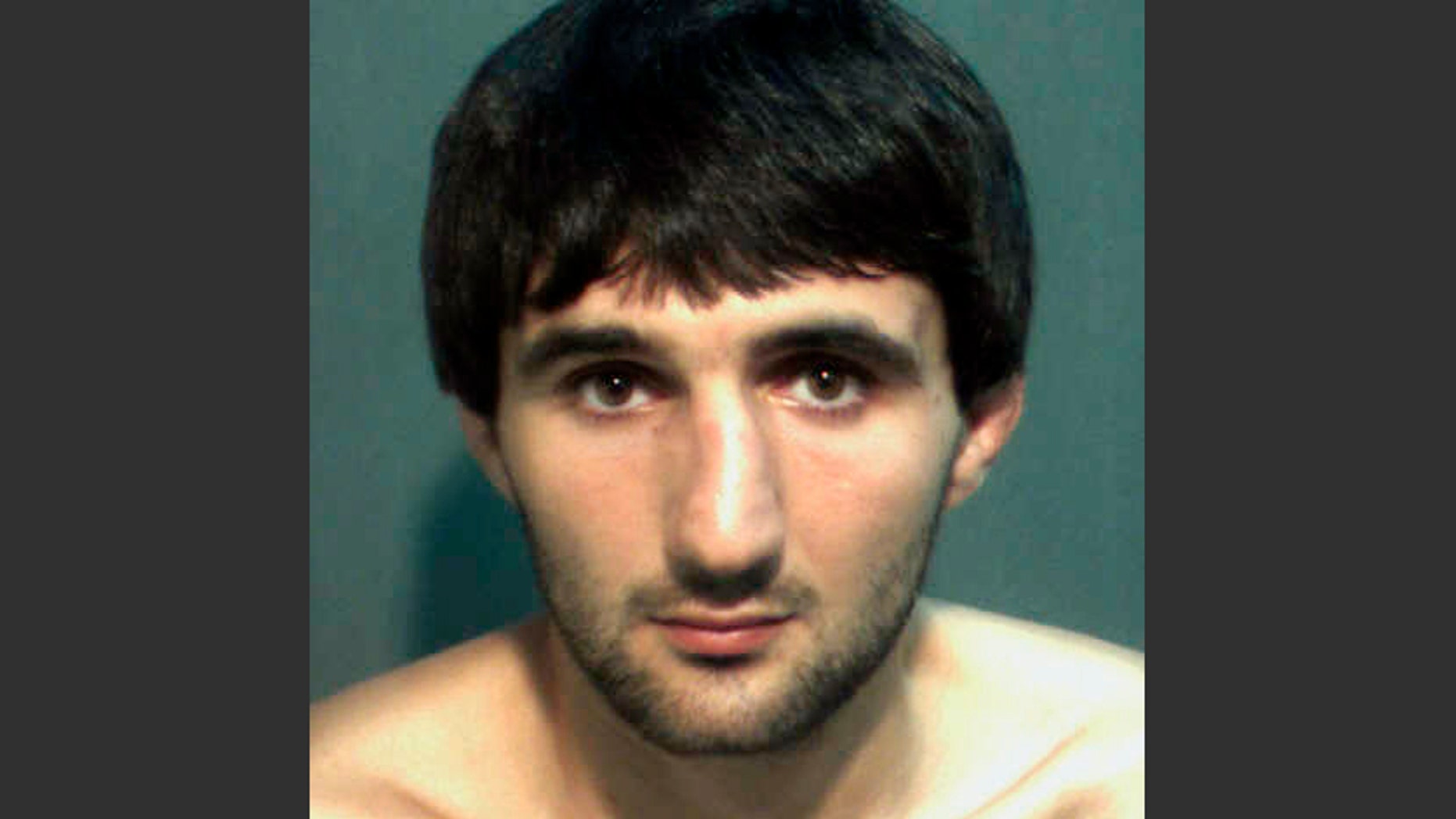 FILE- This May 4, 2013 file photo provided by the Orange County Corrections Department in Orlando, Fla., shows Ibragim Todashev after his arrest for aggravated battery in Orlando. A report released Tuesday, March 25, 2014, determined that an FBI agent was justified in fatally shooting Todashev, who became violent after he had agreed to give a statement about his involvement in a triple slaying in Massachusetts last May. (AP Photo/Orange County Corrections Department)