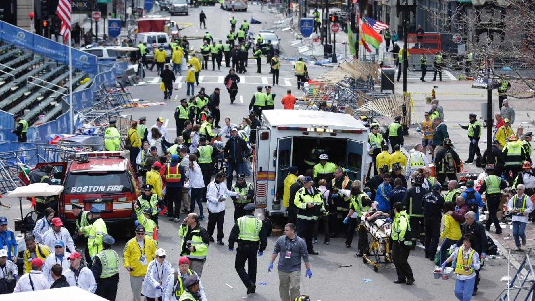 FILE - This April 15, 2013 file photo shows medical workers aid injured people following an explosion at the finish line of the 2013 Boston Marathon in Boston. In the days after the Boston Marathon bombing, the nation’s political leaders pledged resources and support for a city grappling with the first terrorist attack on American soil since Sept. 11, 2001. But nearly a year after homemade bombs ripped through the marathon's finish line, there is little evidence of any lasting impact on the political world. Federal funding that helps cities prepare for terrorism may be cut. And state and federal officials have enacted virtually no policy changes in response to the attack, a dramatic departure from previous acts of terrorism that prompted a wave of government action. (AP Photo/Charles Krupa, File)