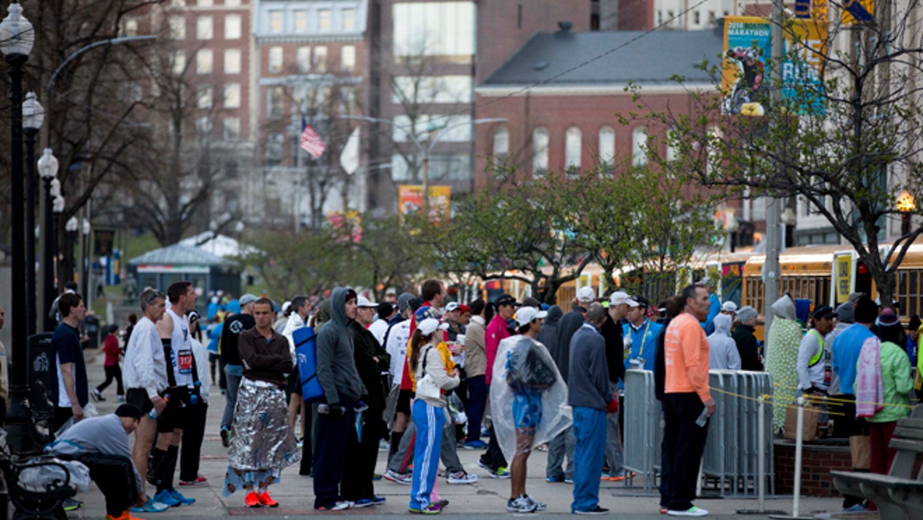 Runners cue to board busses ahead of the 118th Boston Marathon Monday, April 21, 2014 in Boston. (AP Photo/Matt Rourke)