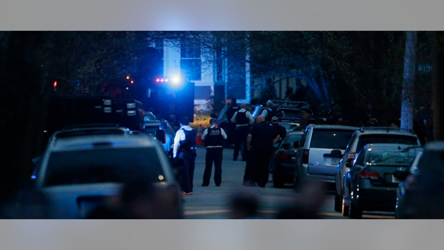 Law enforcement search for the suspect in the Boston Marathon bombings, Friday, April 19, 2013, in Watertown, Mass. Gunfire erupted Friday night amid the manhunt for the surviving suspect in the Boston Marathon bombing, and police in armored vehicles and tactical gear rushed into the Watertown neighborhood in a possible break in the case. (AP Photo/Matt Rourke)