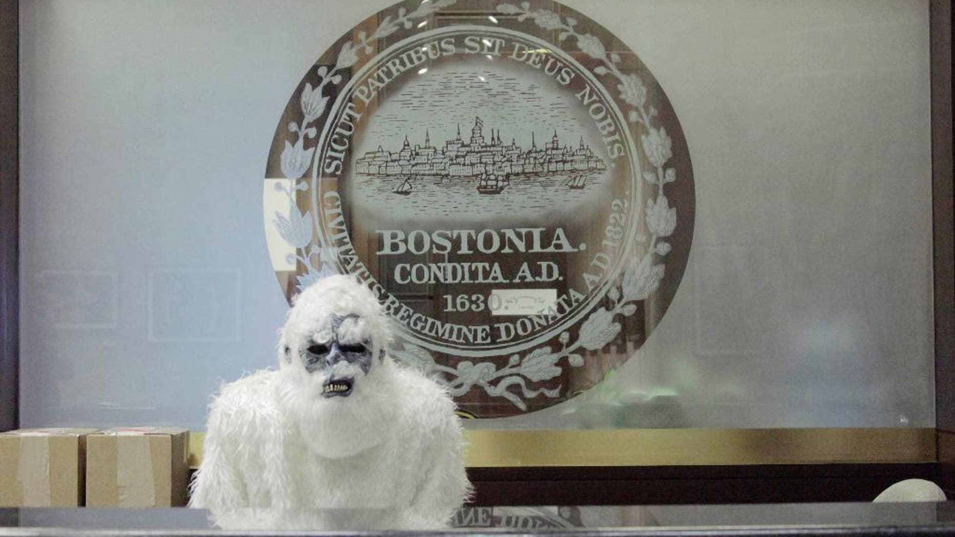 March 6, 2015: In this file photo provided by Eric Gulliver, an anonymous creature known as The Boston Yeti poses in front of the Boston logo at City Hall in Boston.