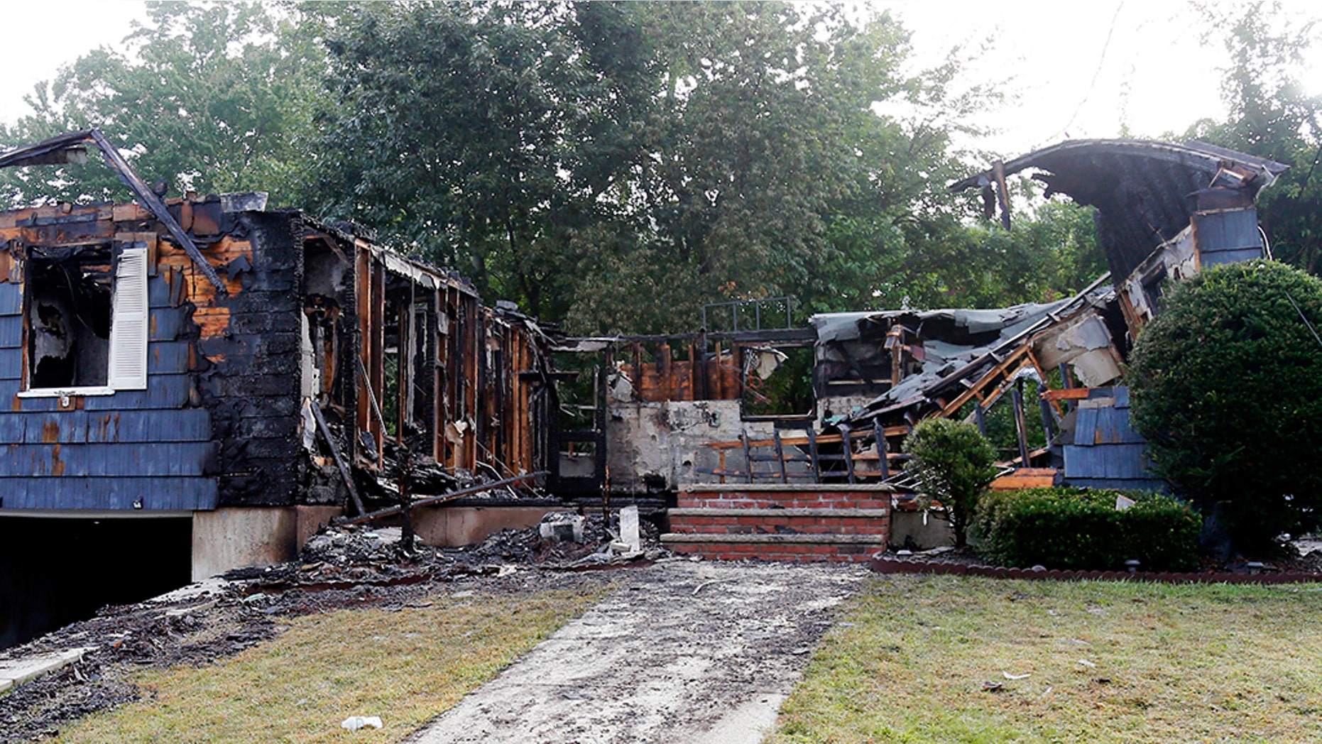 The house owned by Lawrence Police Officer Ivan Soto sits nearly burned to the ground on Jefferson Street, in Lawrence, Mass., Friday, Sept. 14, 2018.