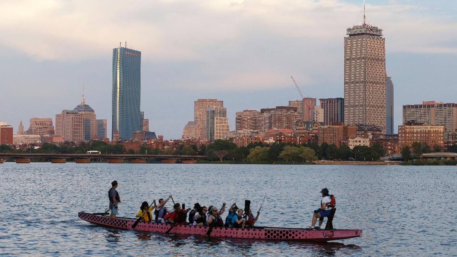 A boat glides along the Cambridge, Mass., side of the Charles River, Monday, July 27, 2105, in front of the Boston skyline, behind. The U.S. Olympic Committee officially severed ties with Boston on Monday, saying it was exploring other options amid lackluster public support and concerns from elected leaders and organized opposition about the impact to taxpayers. (AP Photo/Steven Senne)